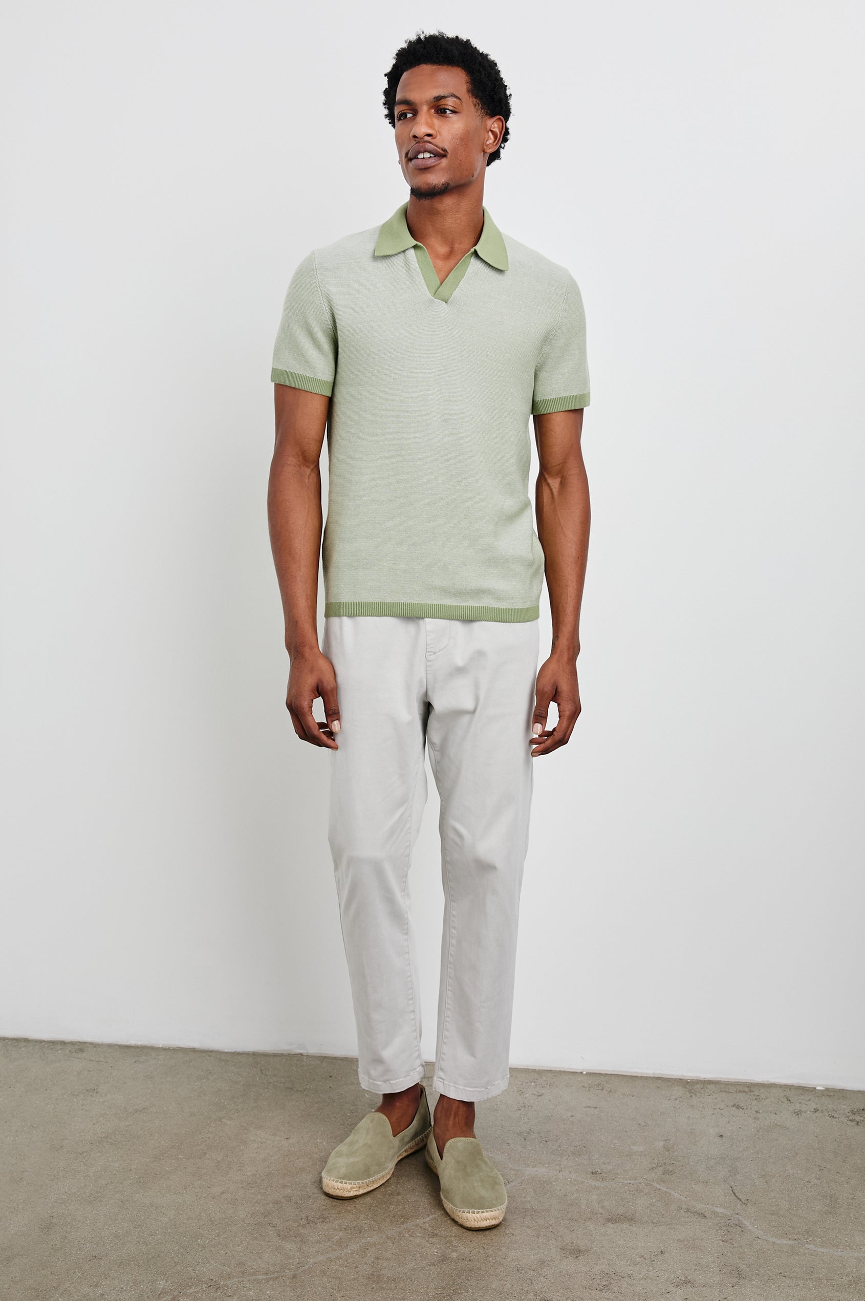 Pearson Short-Sleeve Polo Shirt with a Buttonless Placket in Fern Colorway, with a collar and trim in a darker green - Front Full Body View Featured on Model