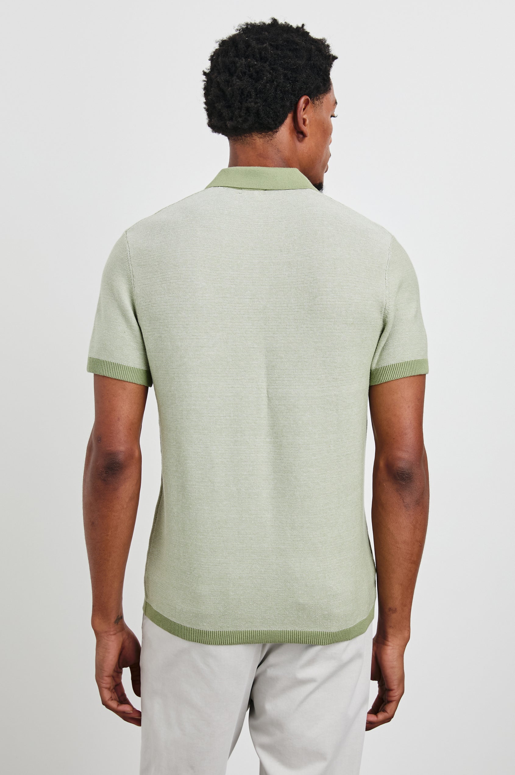 Pearson Short-Sleeve Polo Shirt with a Buttonless Placket in Fern Colorway, with a collar and trim in a darker green - Back View Featured on Model