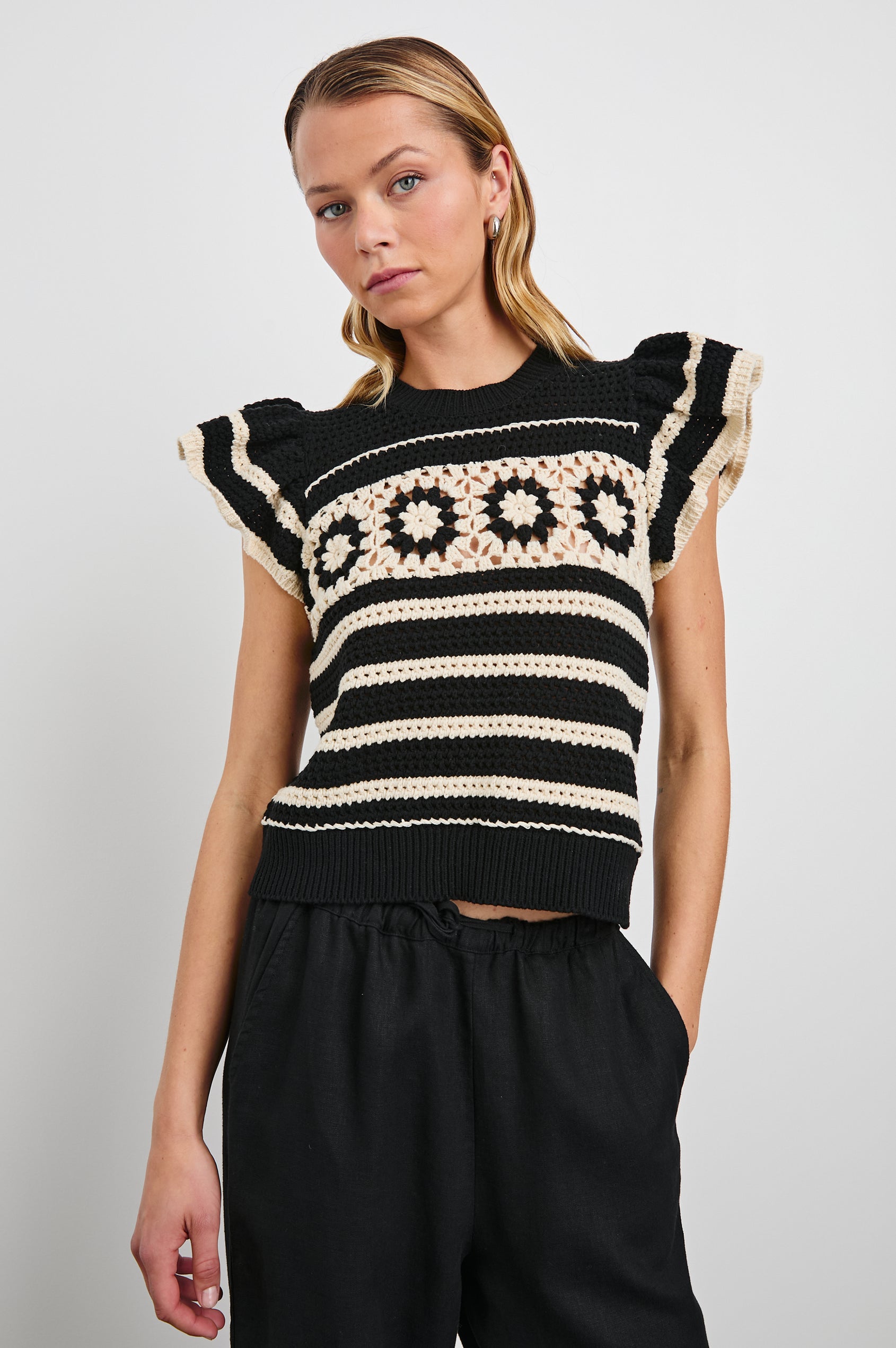 Penelope Crochet Top with Flutter Sleeves and Ribbed Hem in Black Ivory Stripe Colorway, Horizontal Stripes with Contrasting Knit Flowers Across the Chest - Front View Featured on Model
