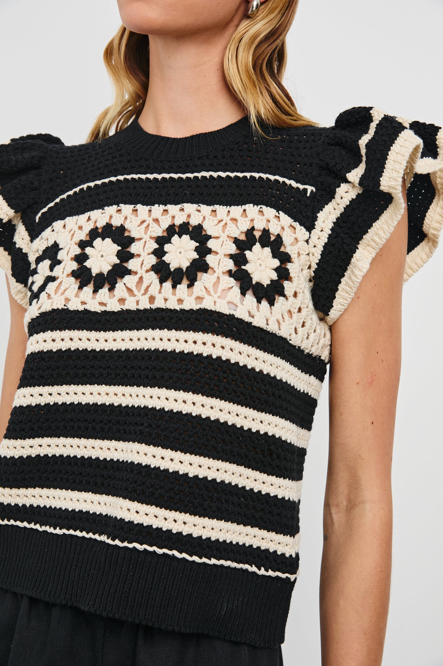 Penelope Crochet Top with Flutter Sleeves and Ribbed Hem in Black Ivory Stripe Colorway, Horizontal Stripes with Contrasting Knit Flowers Across the Chest - Front View Featured on Model