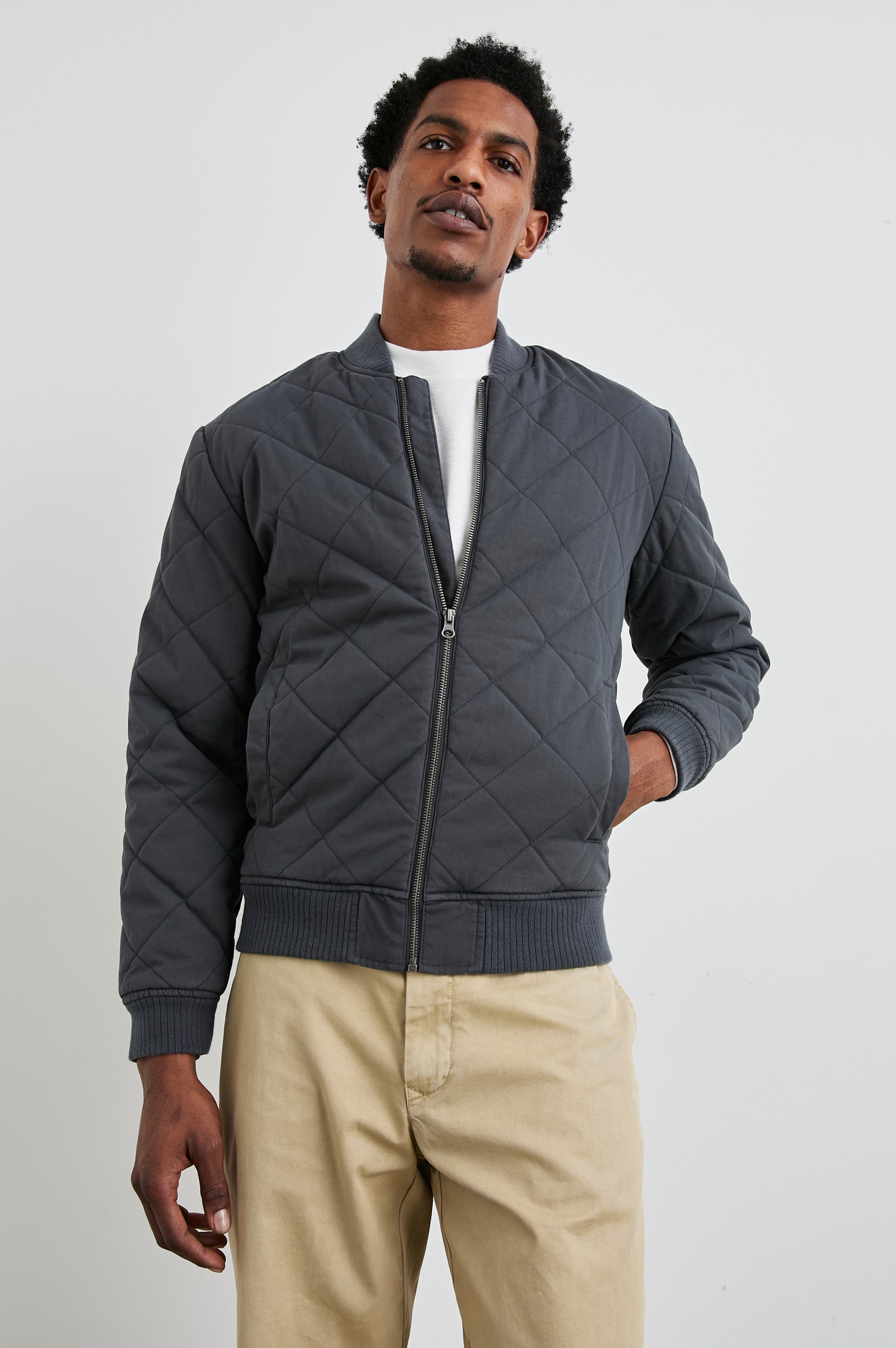 Peninsula Jacket with Zip Closure, Two Front Pockets, an Inner Zippered Pocket, a Quilted Pattern and Ribbed Trim in Obsidian Colorway - Front View Featured on Model