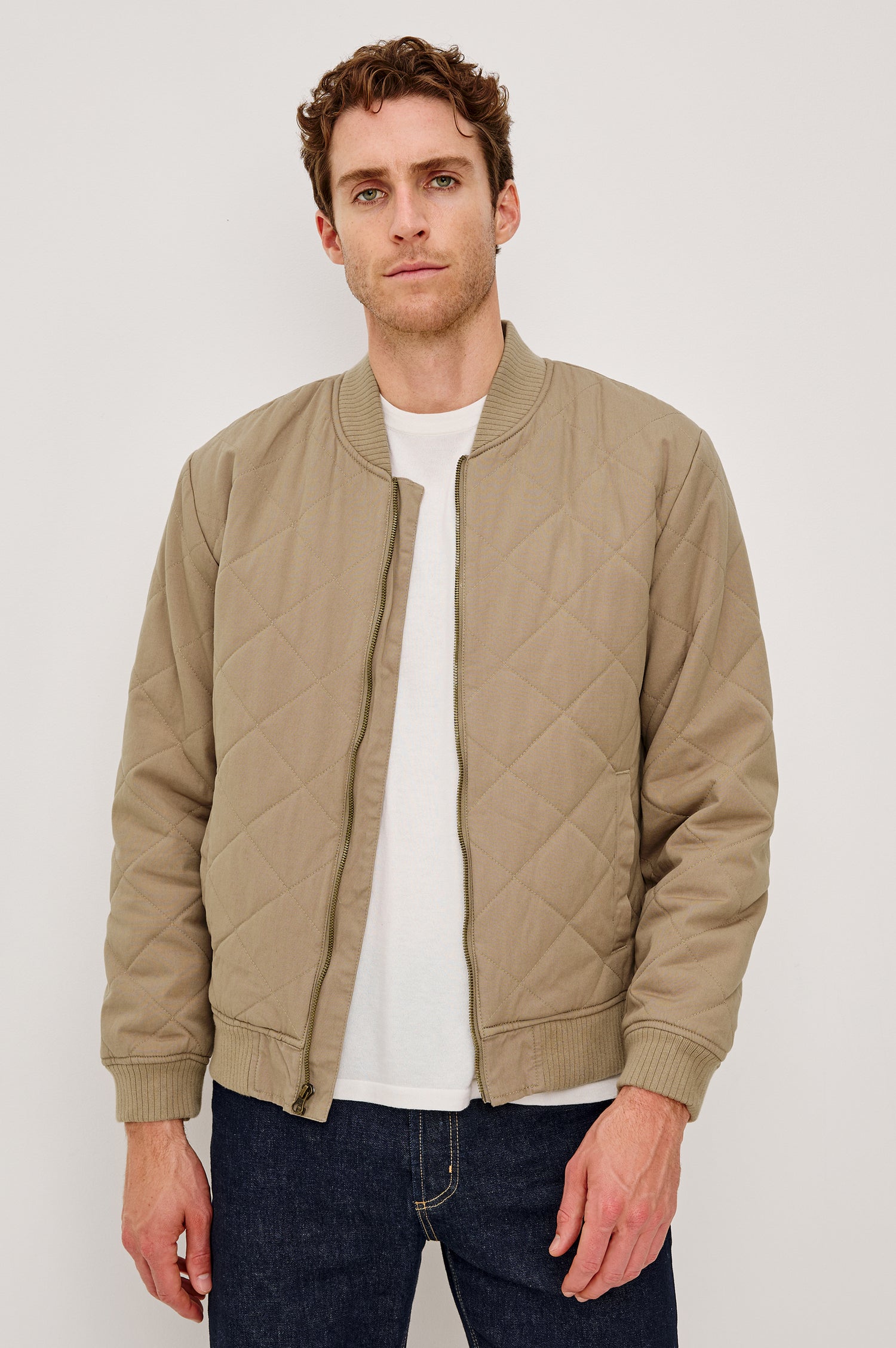 Peninsula Jacket with Zip Closure, Two Front Pockets, an Inner Zippered Pocket, a Quilted Pattern and Ribbed Trim in Vintage Khaki Colorway - Front View Featured on Model
