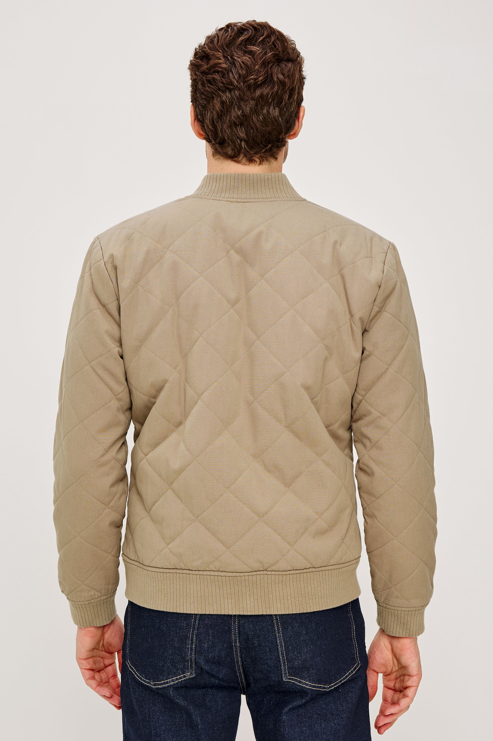 Peninsula Jacket with Zip Closure, Two Front Pockets, an Inner Zippered Pocket, a Quilted Pattern and Ribbed Trim in Vintage Khaki Colorway - Back View Featured on Model