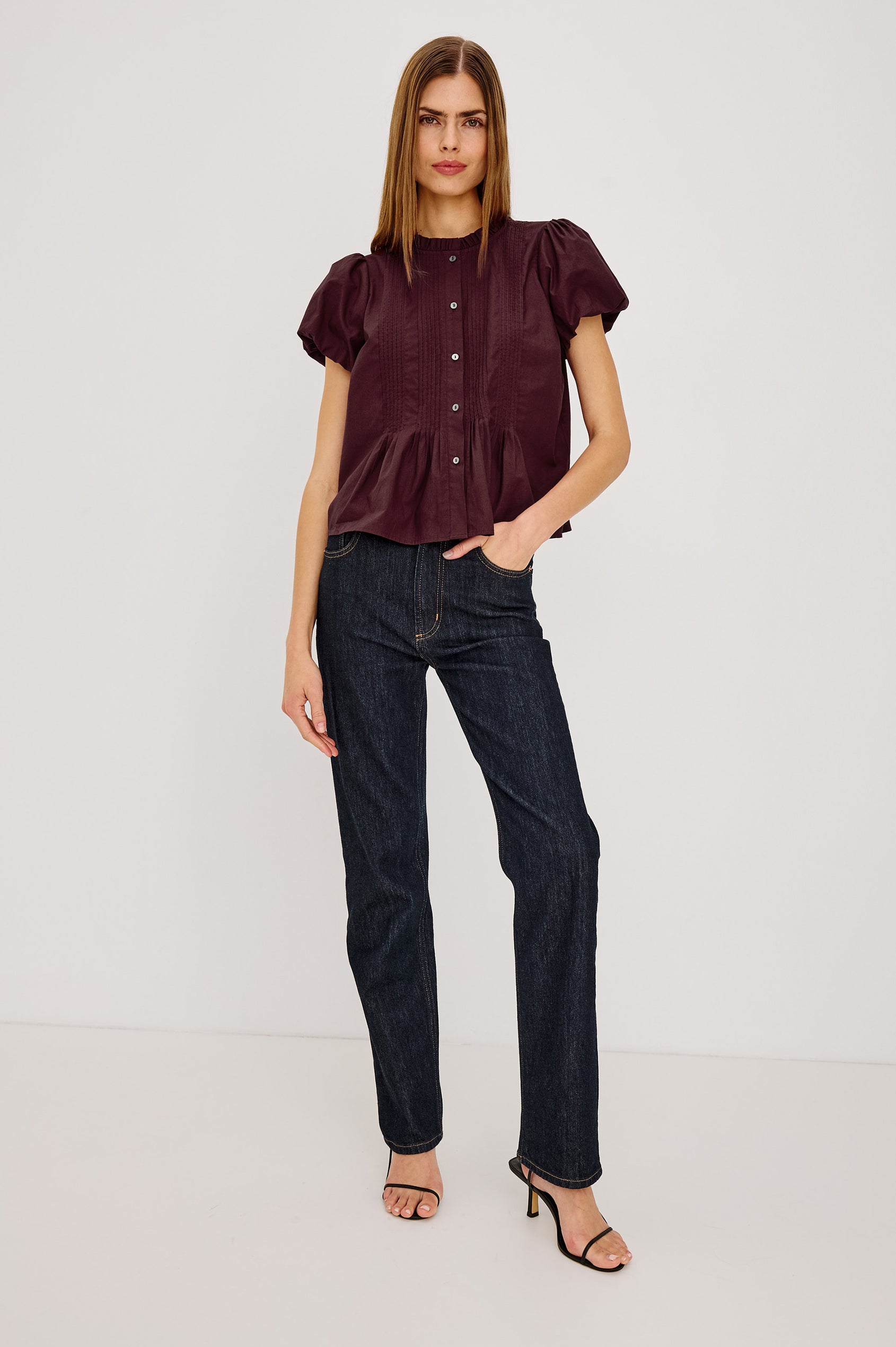 Pepper Shirt in Cotton Poplin With Loose Boxy Fit, Pintuck Detailing, Puff Cap Sleeves, Center-Front Buttons, and Soft Peplum Hem in Port Colorway - Full Body Front View Featured on Model