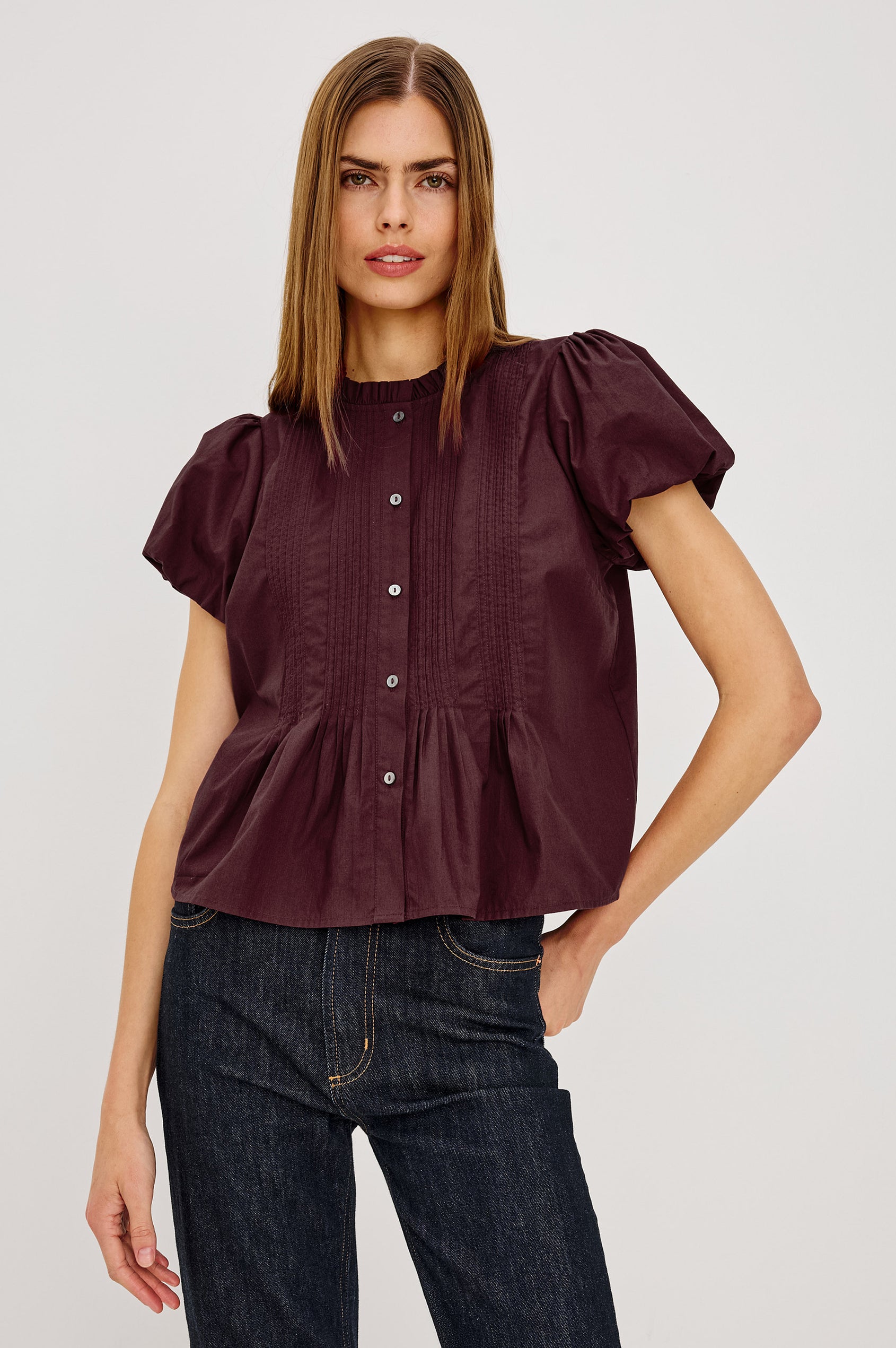 Pepper Shirt in Cotton Poplin With Loose Boxy Fit, Pintuck Detailing, Puff Cap Sleeves, Center-Front Buttons, and Soft Peplum Hem in Port Colorway - Upper Body Front View Featured on Model