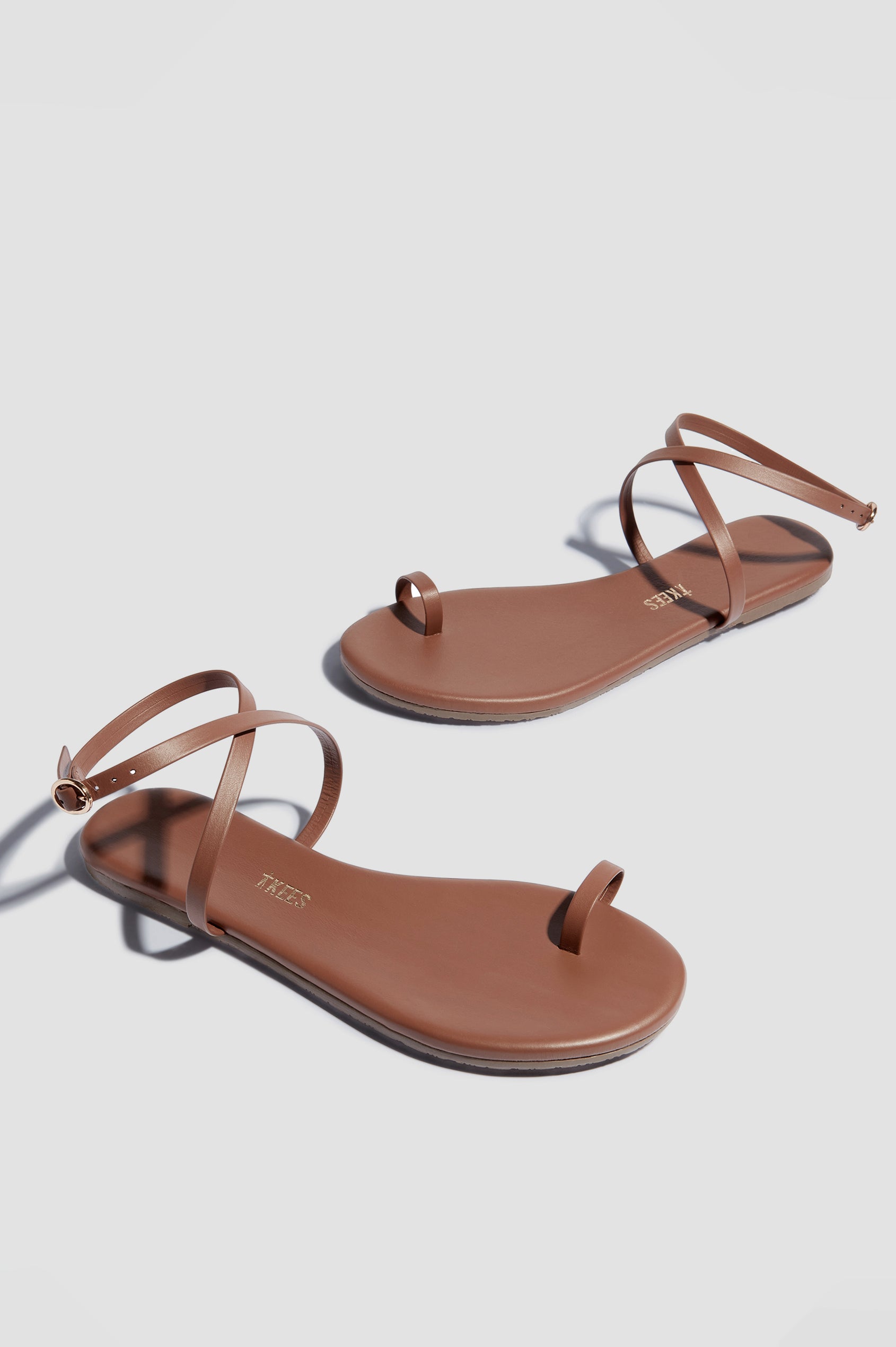 Phoebe leather sandal with toe ring and crossed ankle strap with buckle in Heatwave - cross angled view of pair of shoes