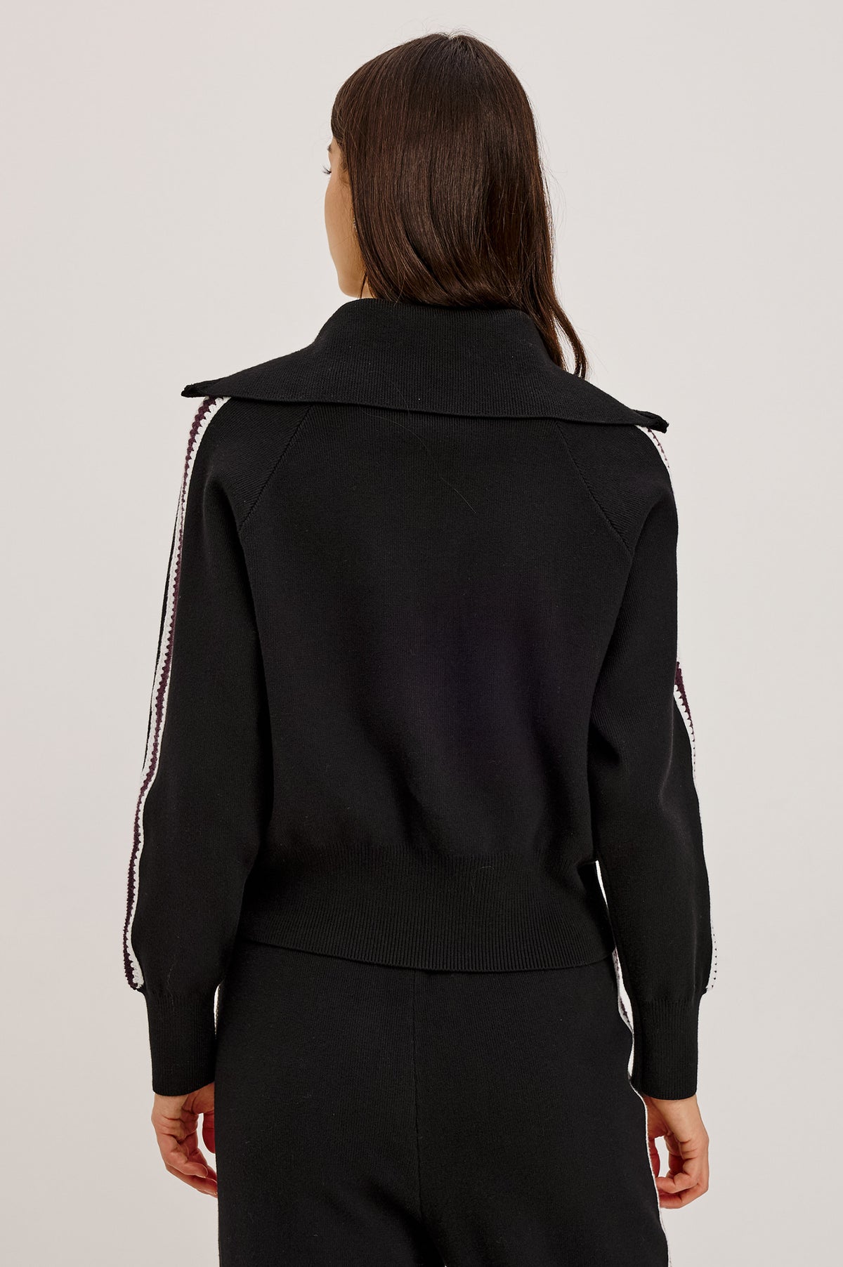 Piper Track Sweater Jacket in Cotton-Blend Knit With Shawl Collar, Double-Zip Front, and Contrast Crochet Stripes Down Long Sleeves in Black Merlot Stripe Colorway - Upper Body Back View Featured on Model.