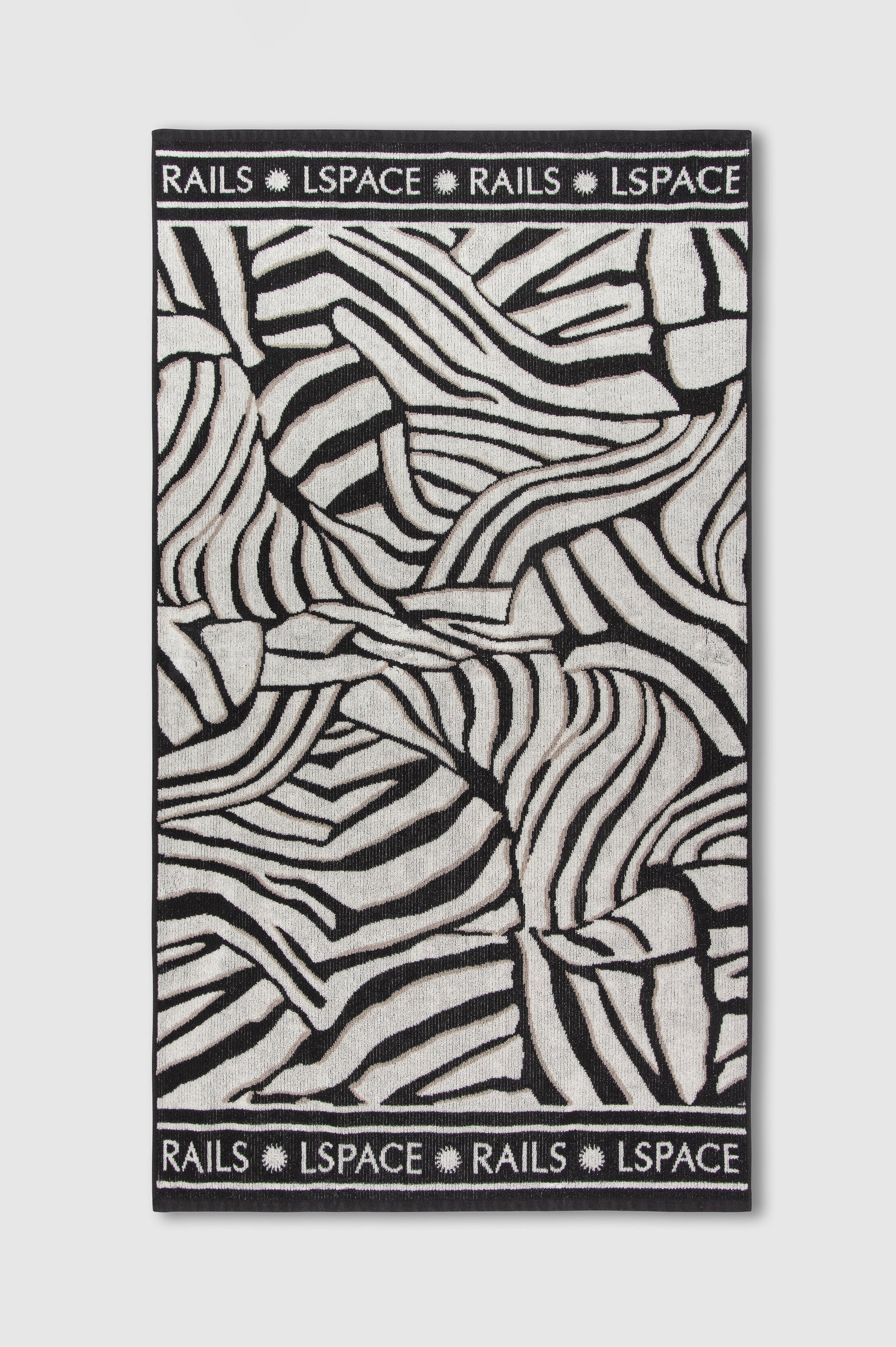 Playa Blanca Towel in Playa Blanca black and white abstract print with Rails and LSpace logo on the edge - flat view of entire towel
