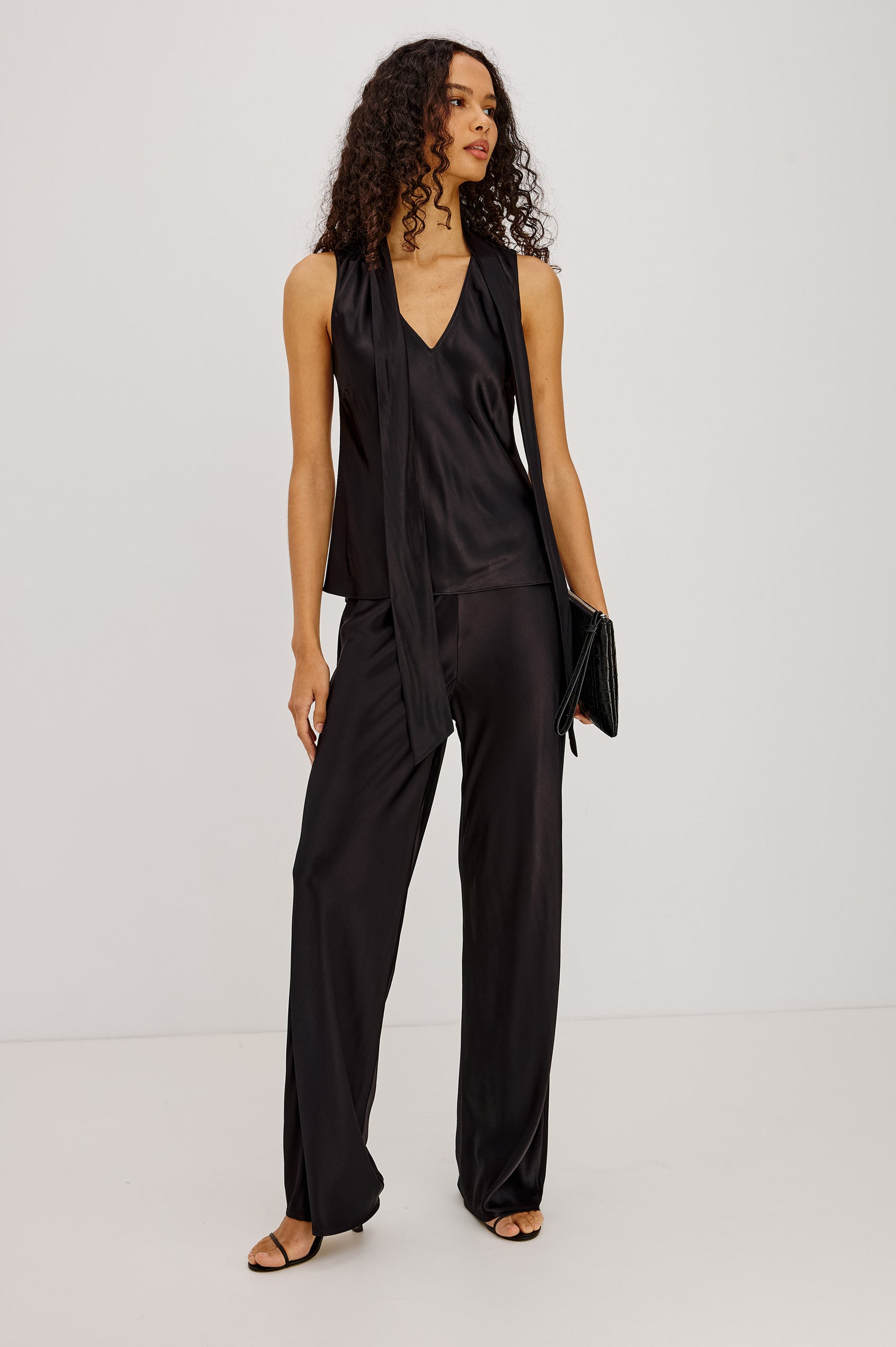 Poppy Shirt in Satin-Back Crepe With Deep V-Neckline, Attached Self-Tie Scarf, and Bias Cut in Black Colorway - Full Body Front View Featured on Model
