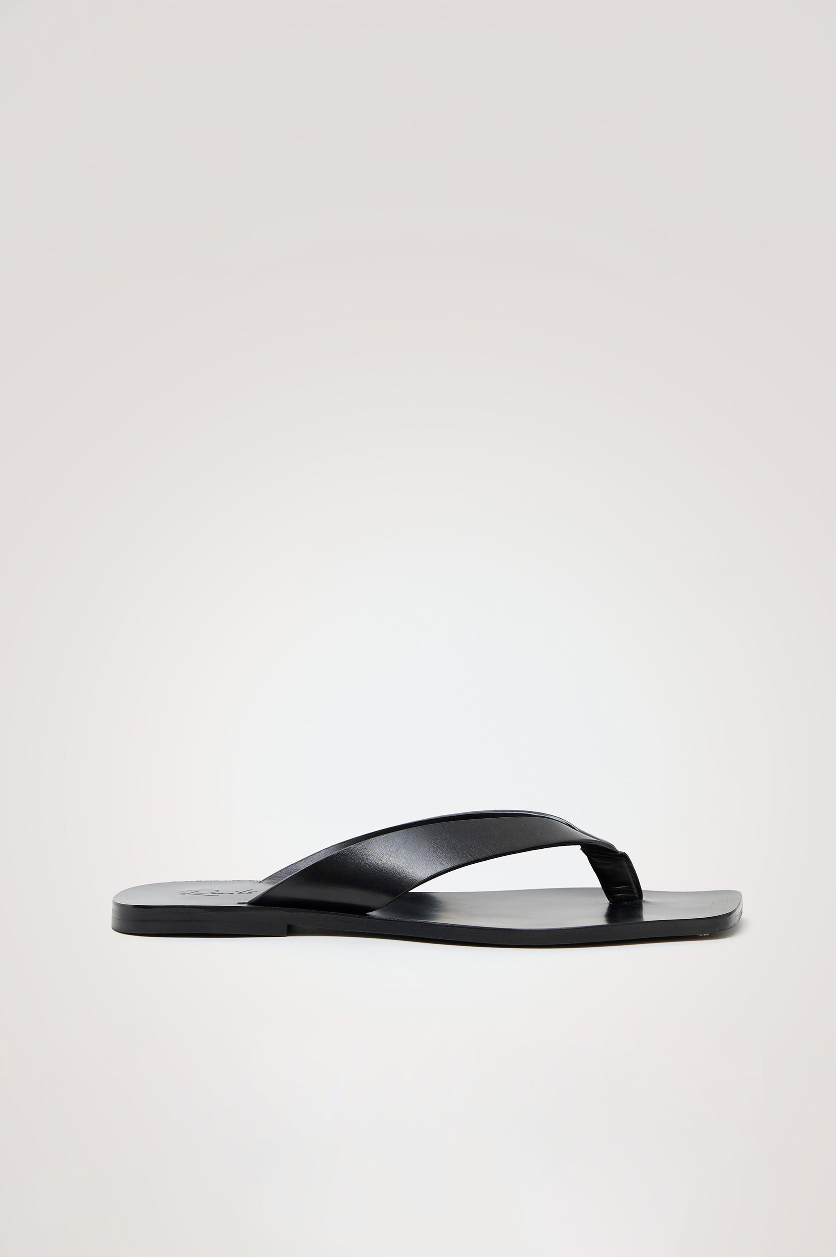 Porto Thong Sandal in Leather With Square Toe and Cushioned Footbed With Branded Embossed Detail in Black Colorway - Front View Featured on Model