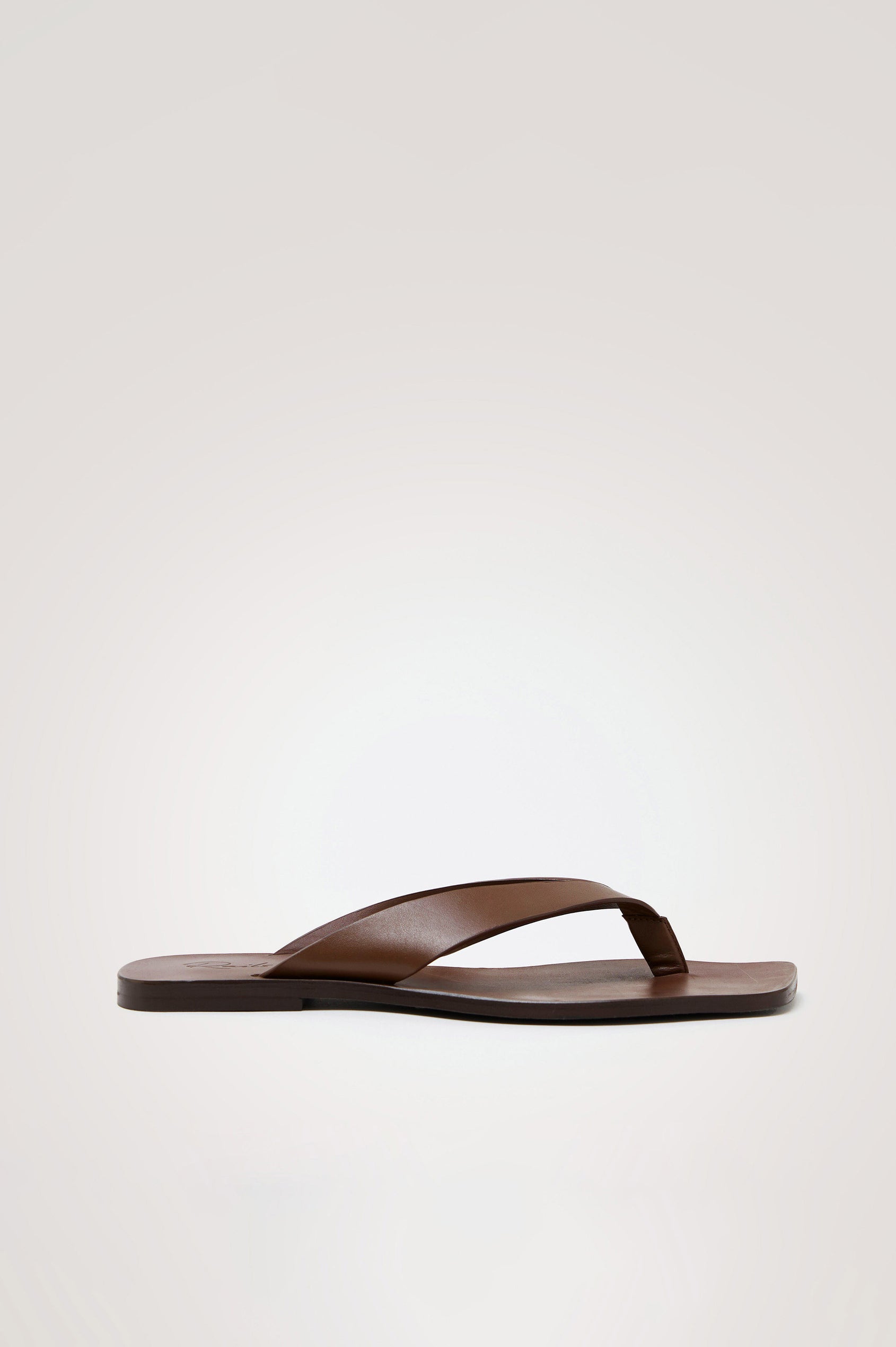Porto Thong Sandal in Leather With Square Toe and Cushioned Footbed With Branded Embossed Detail in Dark Brown Colorway - Side View Featured