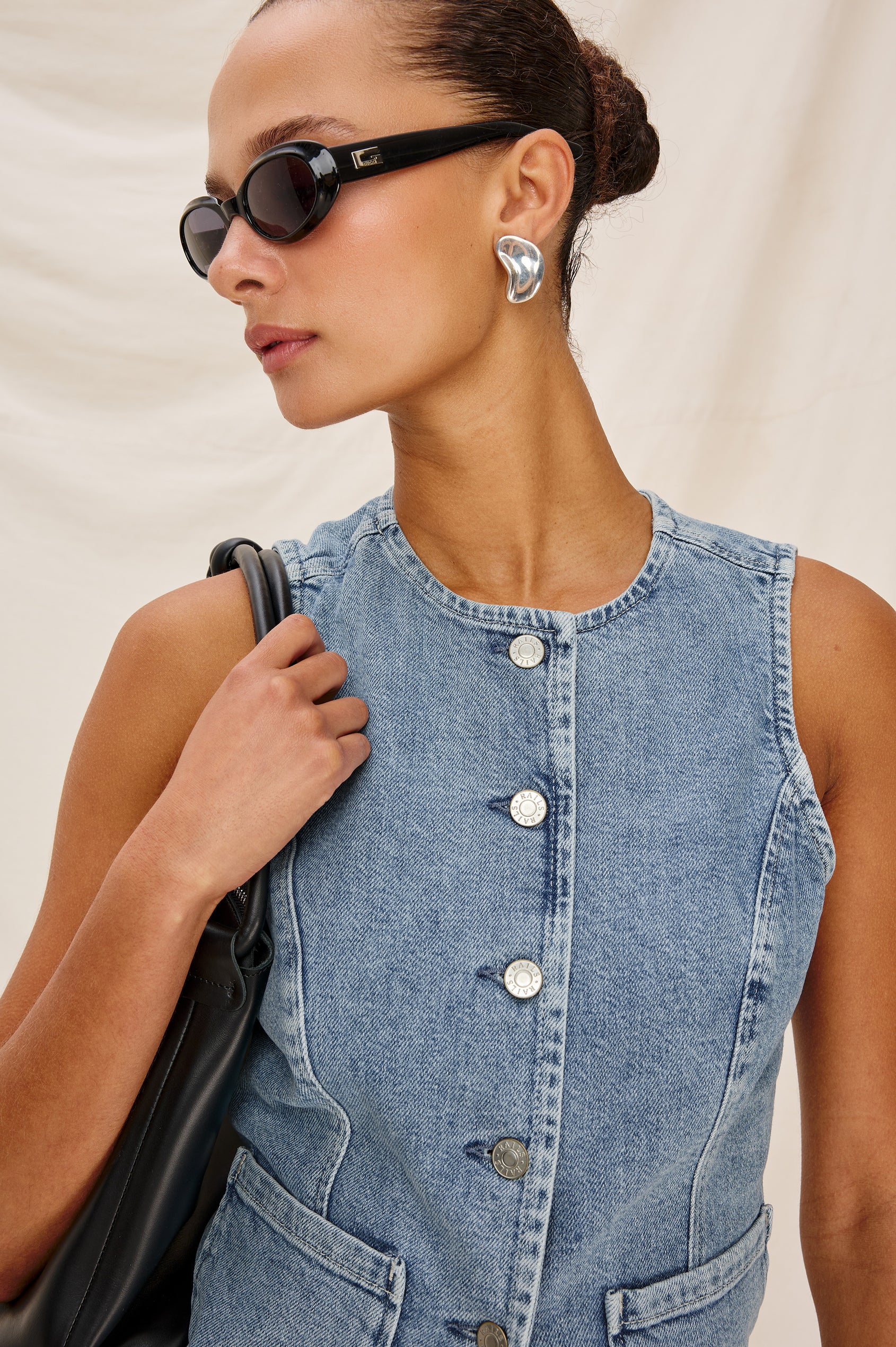 Portola Sleeveless Denim Vest with Exposed Button Front Closure, Crew Neck, Front Patch Pockets and a Scalloped Split Hem in Blue Eyed Girl Colorway. Full Body Front View Shown on Model.