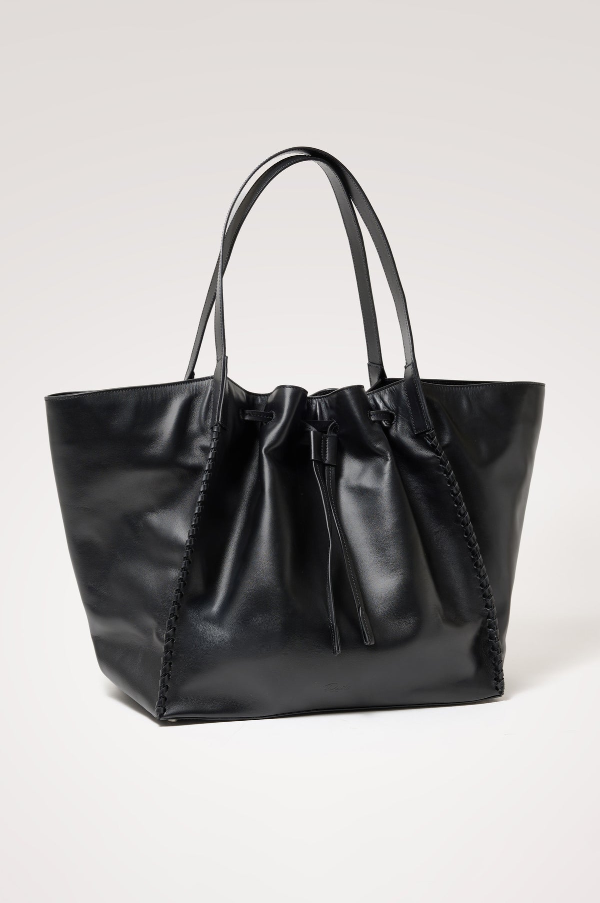 Prato Bucket Tote in Leather With Whipstitch Trim, Fixed Top Straps, Drawcord Closure, Interior Zip Pocket, Interior Slip Pocket in Black Colorway - Front Product View Featured