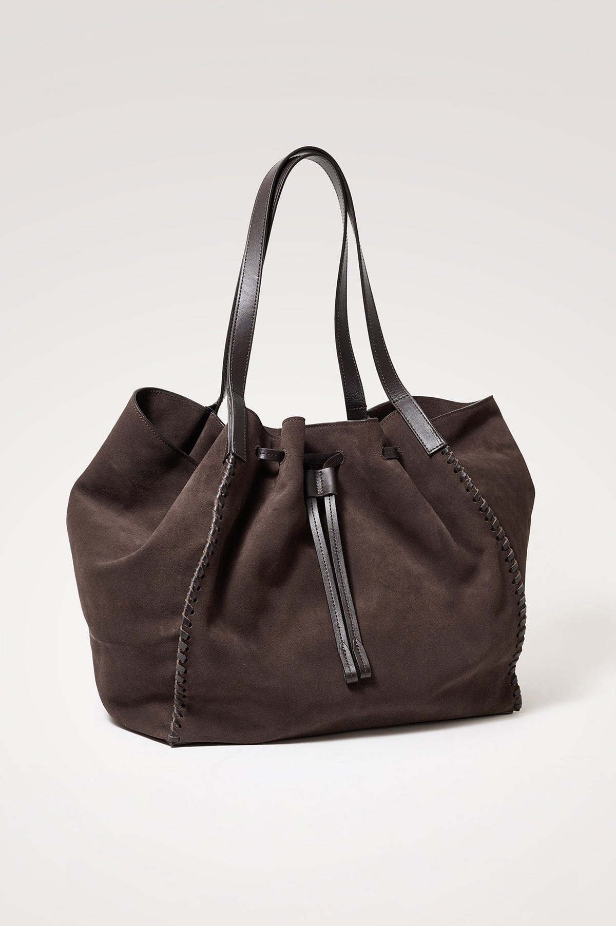 Prato Bucket Tote in Suede With Whipstitch Trim, Fixed Top Straps, Drawcord Closure, Interior Zip Pocket, Interior Slip Pocket in Dark Brown Suede Colorway - Front Product View Featured