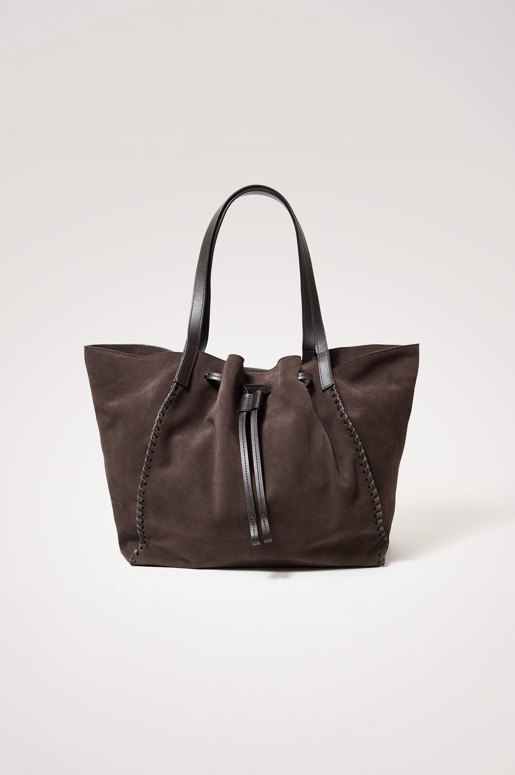Prato Bucket Tote in Suede With Whipstitch Trim, Fixed Top Straps, Drawcord Closure, Interior Zip Pocket, Interior Slip Pocket in Dark Brown Suede Colorway - Front Product View Featured