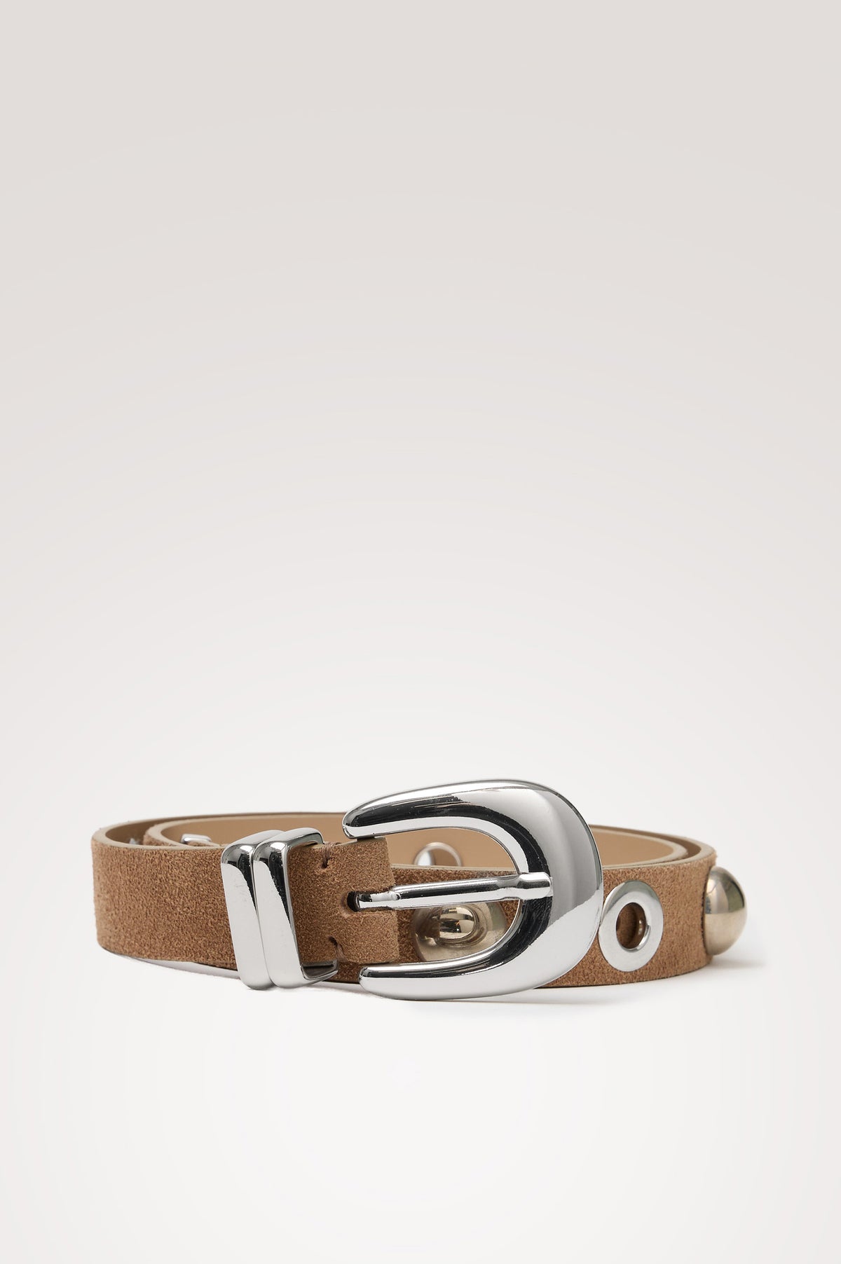 Presley Slim Belt in Leather With Adjustable Buckle and Grommet and Stud Hardware in Taupe Suede Silver Studded Colorway - Coiled View of Belt Featured