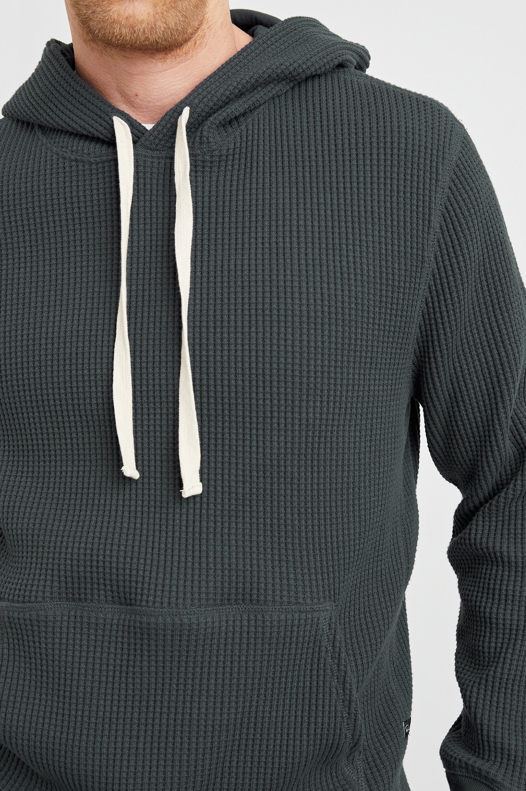 Preston Waffle Thermal Hoodie with a Kangaroo Pouch, Drawstring Hood and Elastic Cuffs in Ink Colorway - Front View Featured on Model