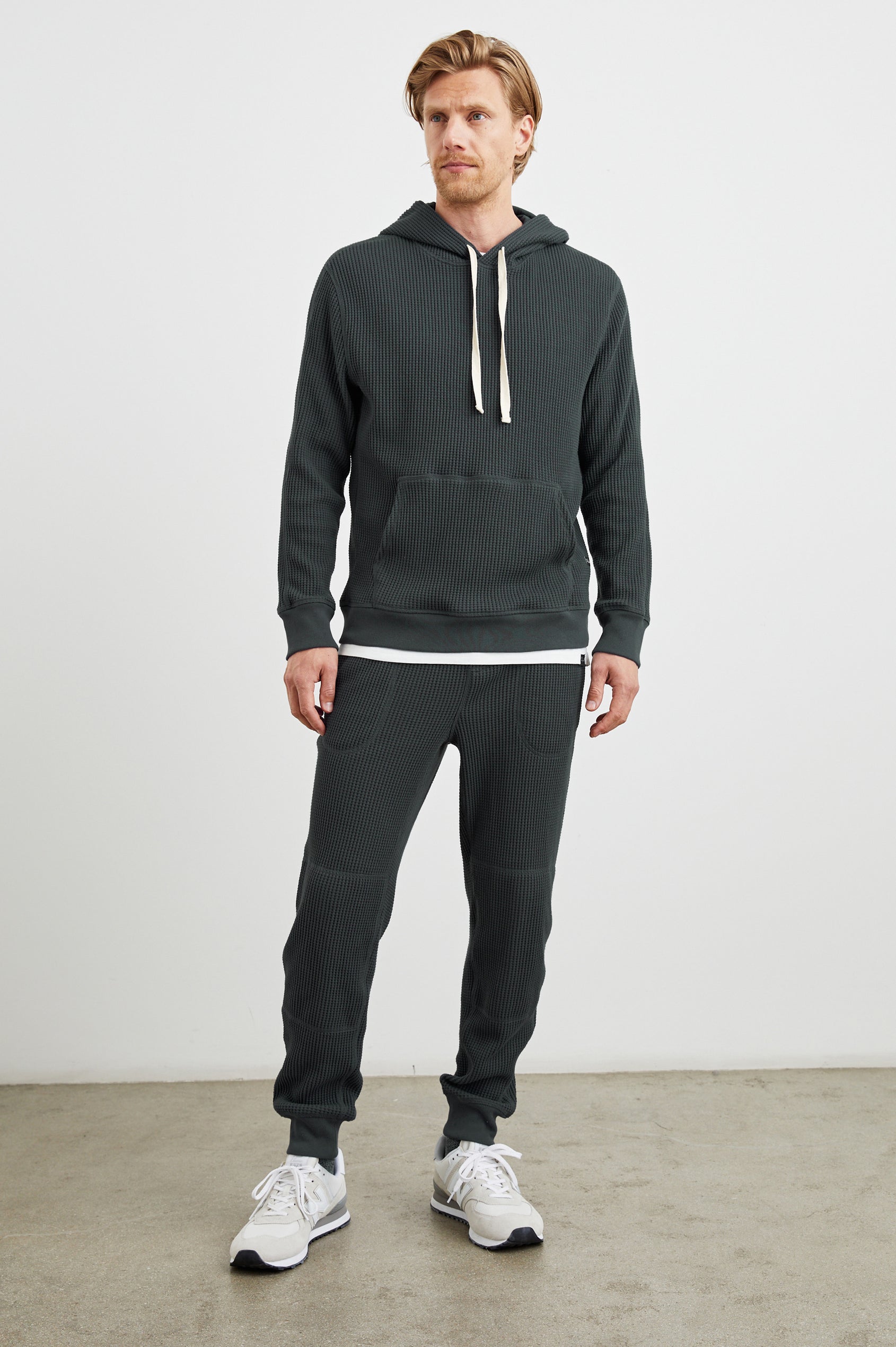 Preston Waffle Thermal Hoodie with a Kangaroo Pouch, Drawstring Hood and Elastic Cuffs in Ink Colorway - Front Full Body View Featured on Model