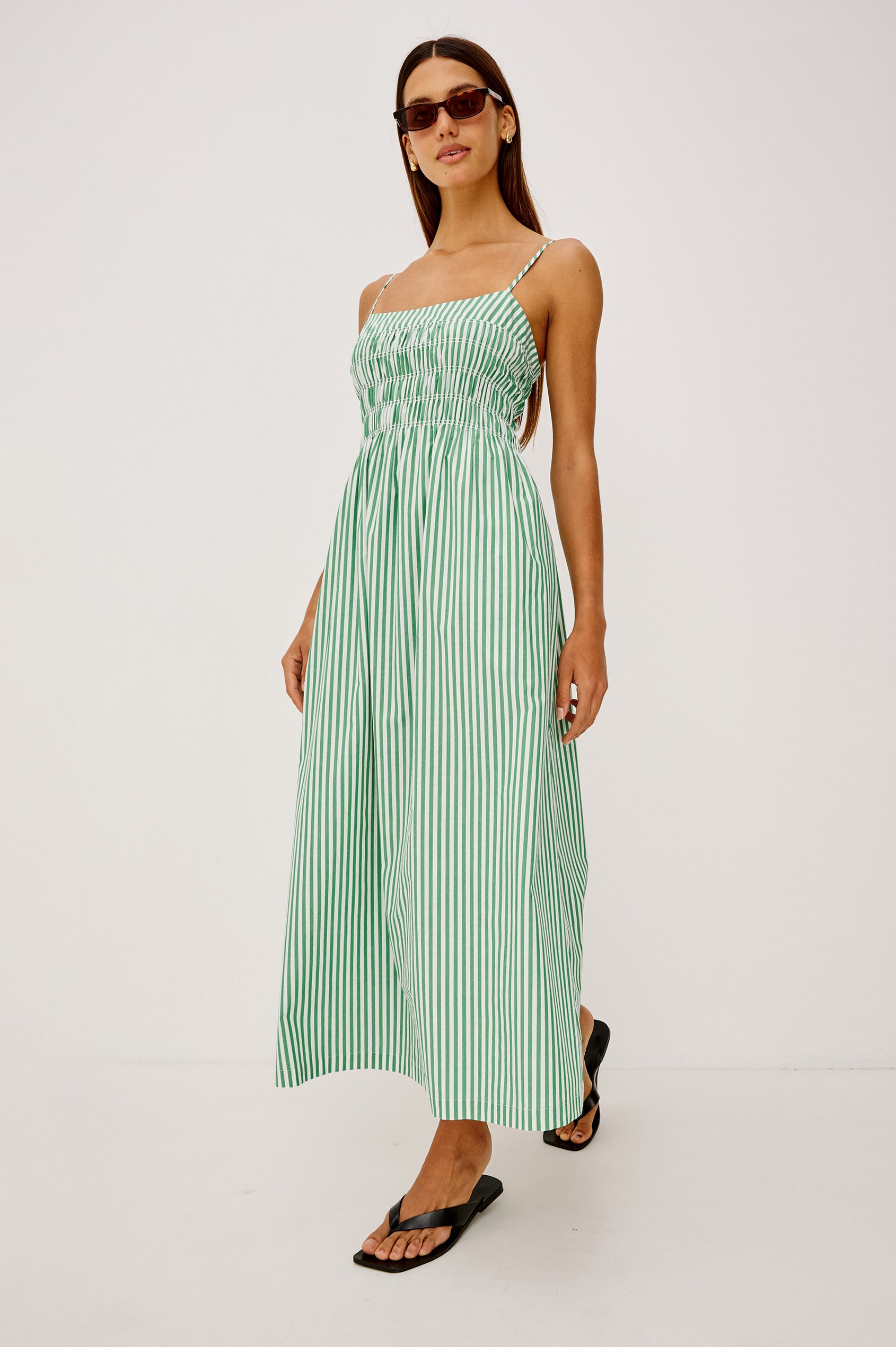 Primrose Midi Dress in Cotton Poplin With Adjustable Spaghetti Straps, Smocked Empire Bodice, and Full Skirt in Emerald Stripe Colorway - Full Body Front View Featured on Model