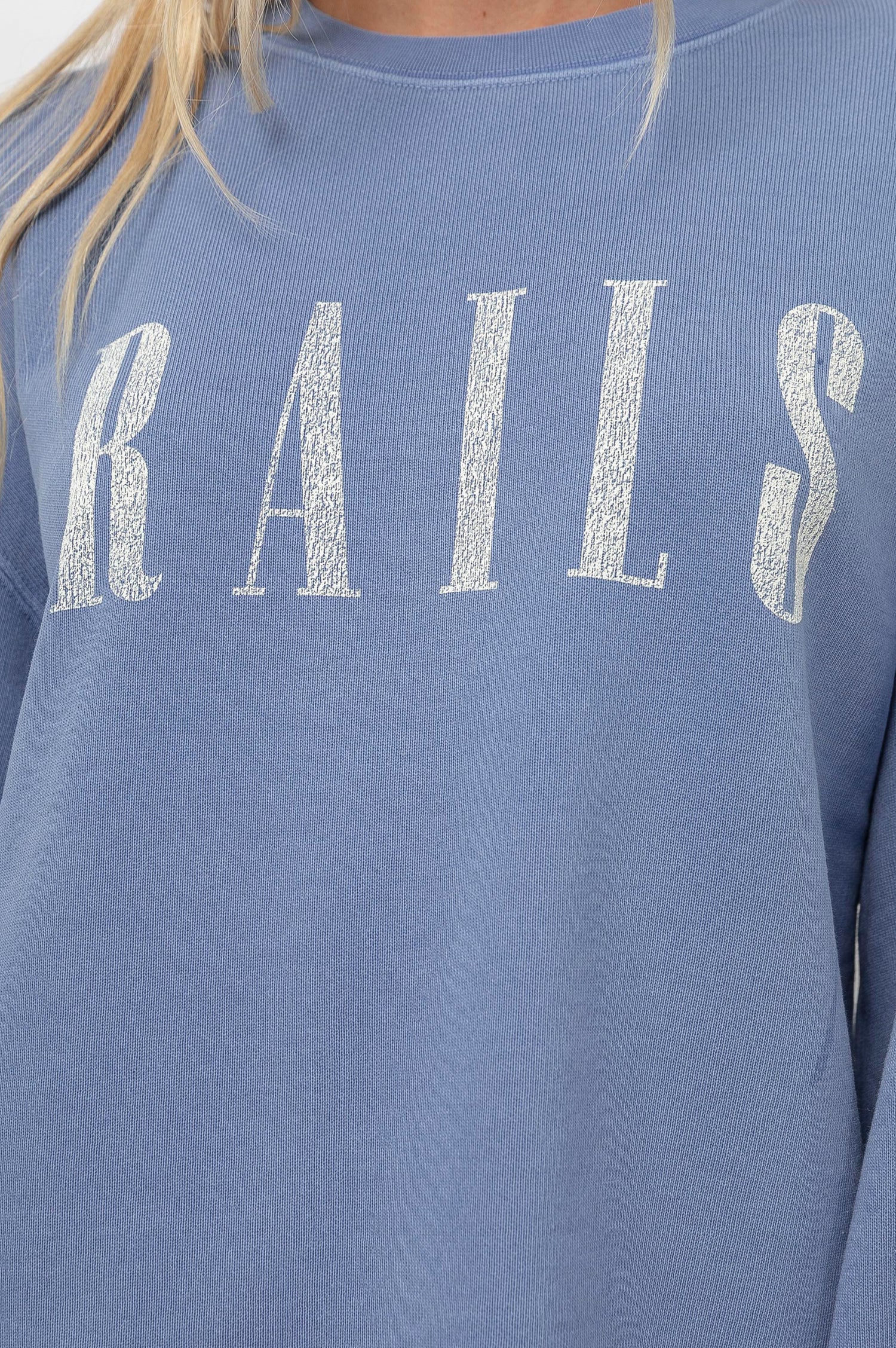 Rails Signature Long-Sleeve Sweatshirt with a Crew Neck, Raw Hem, Shirring Above Cuff, and the Text, Rails, in Washed Indigo Rails Colorway, with Ivory Text - Front View Featured on Model 