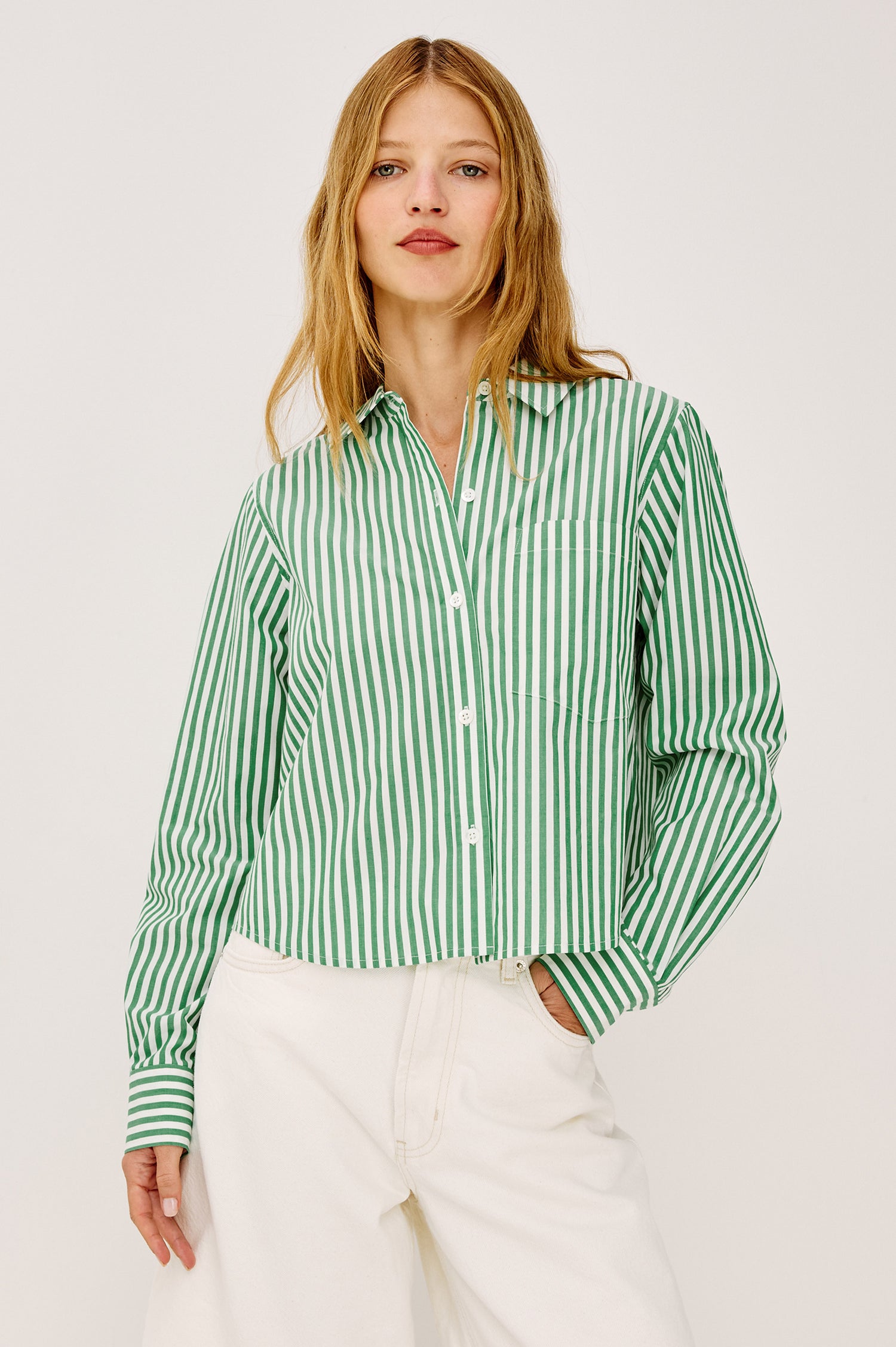 Ramy Crop Shirt in Cotton Poplin With Button-Up Placket, Collar, Chest Patch Pocket, Long Sleeves, and a Loose, Boxy Fit in Emerald Stripe Colorway - Upper Body Front View Featured on Model