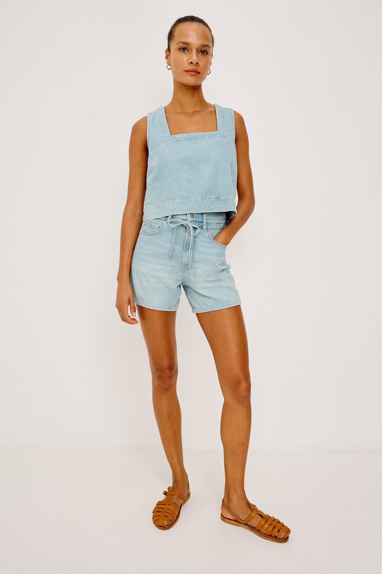Rancho Short in Cotton Lyocell Denim With High-Rise, Pinched Waist, A-Line Silhouette, Relaxed Saddle, Front Drawcord Ties, and Zip Fly in Surf Colorway - Full Body Front View Featured on Model