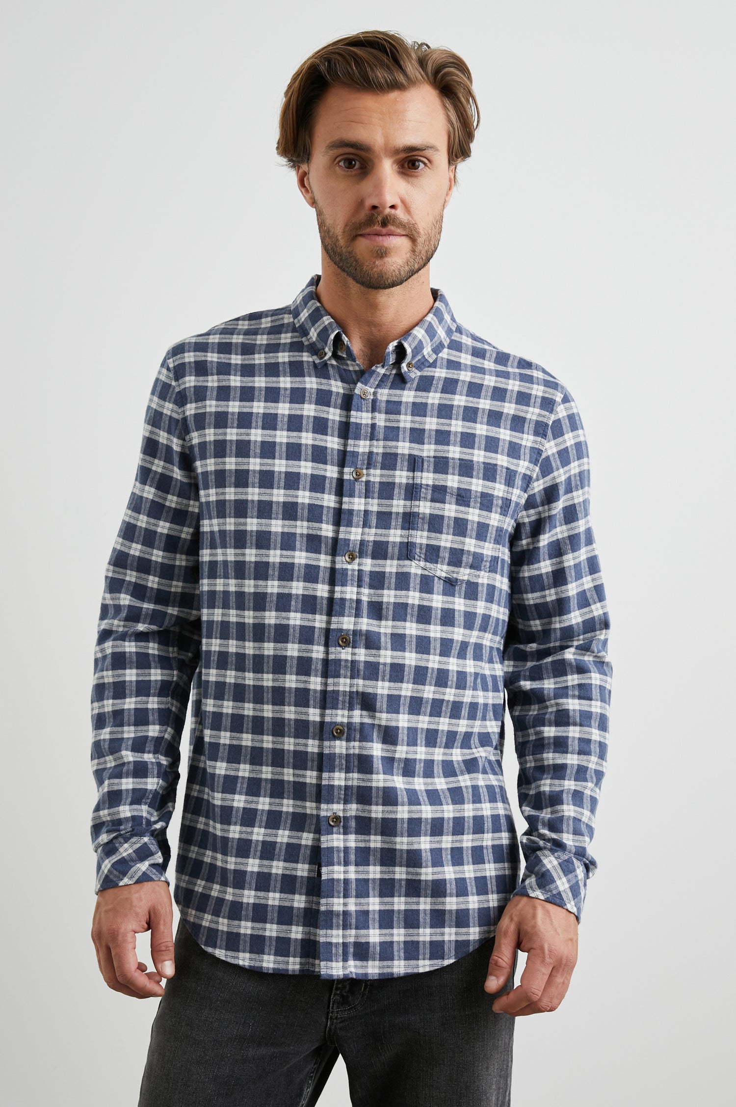 Reid Long-Sleeve Button Up with a Patch Pocket in Midnight Grey Melange Colorway, a Blue, Grey and Cream plaid - Front View Featured on Model