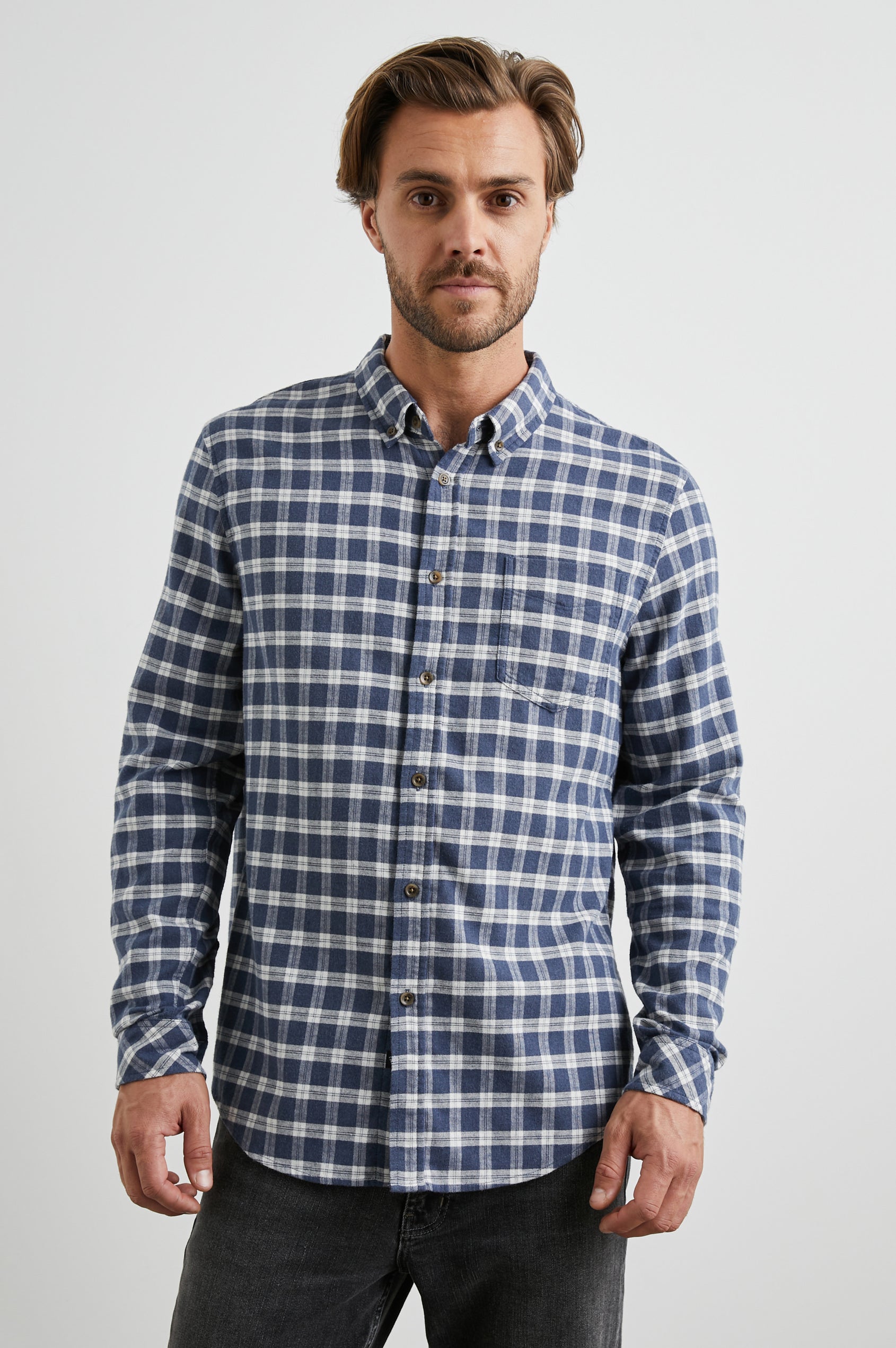 Reid Long-Sleeve Button Up with a Patch Pocket in Midnight Grey Melange Colorway, a Blue, Grey and Cream plaid - Front View Featured on Model