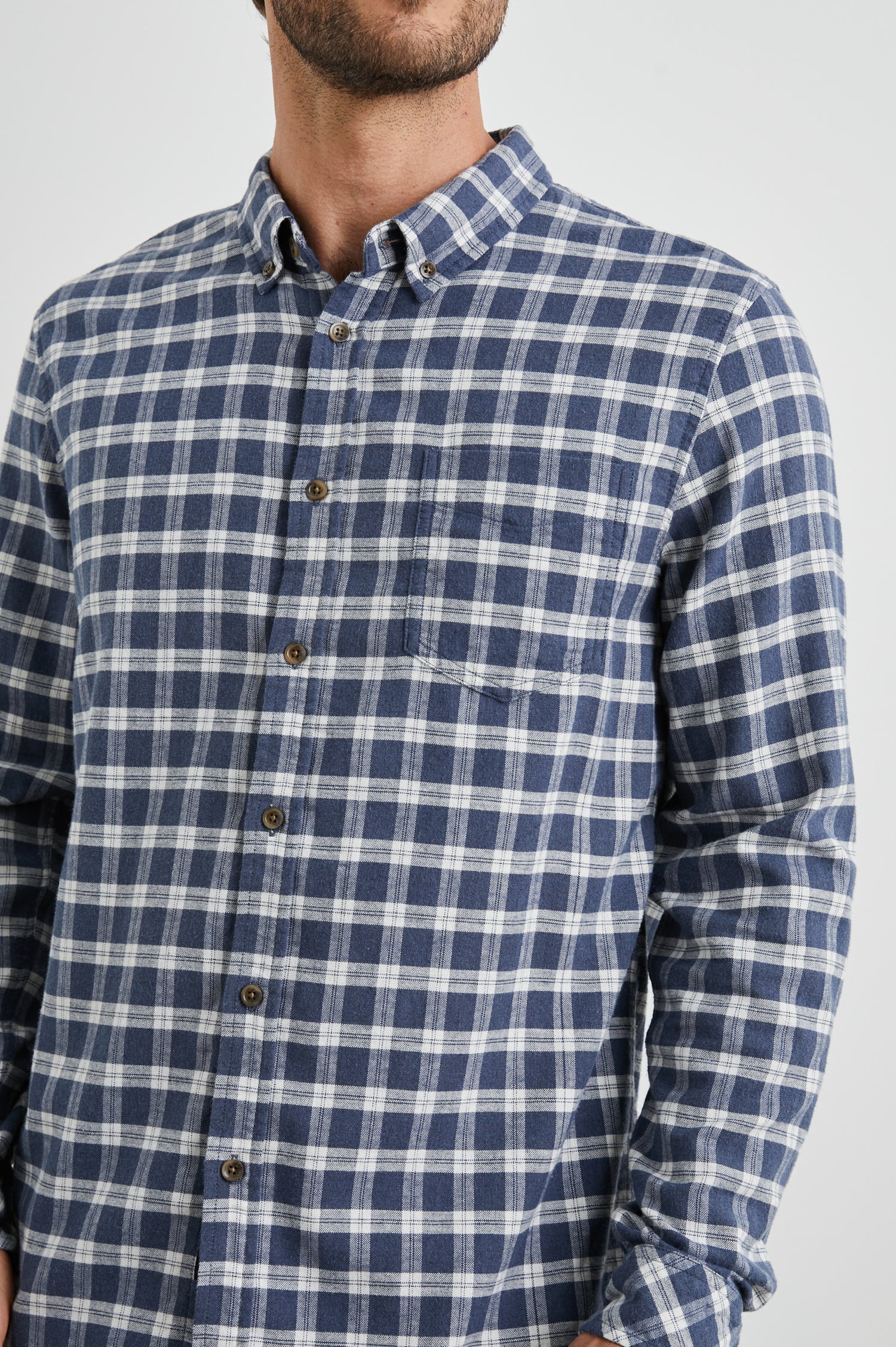 Reid Long-Sleeve Button Up with a Patch Pocket in Midnight Grey Melange Colorway, a Blue, Grey and Cream plaid - Front View Featured on Model