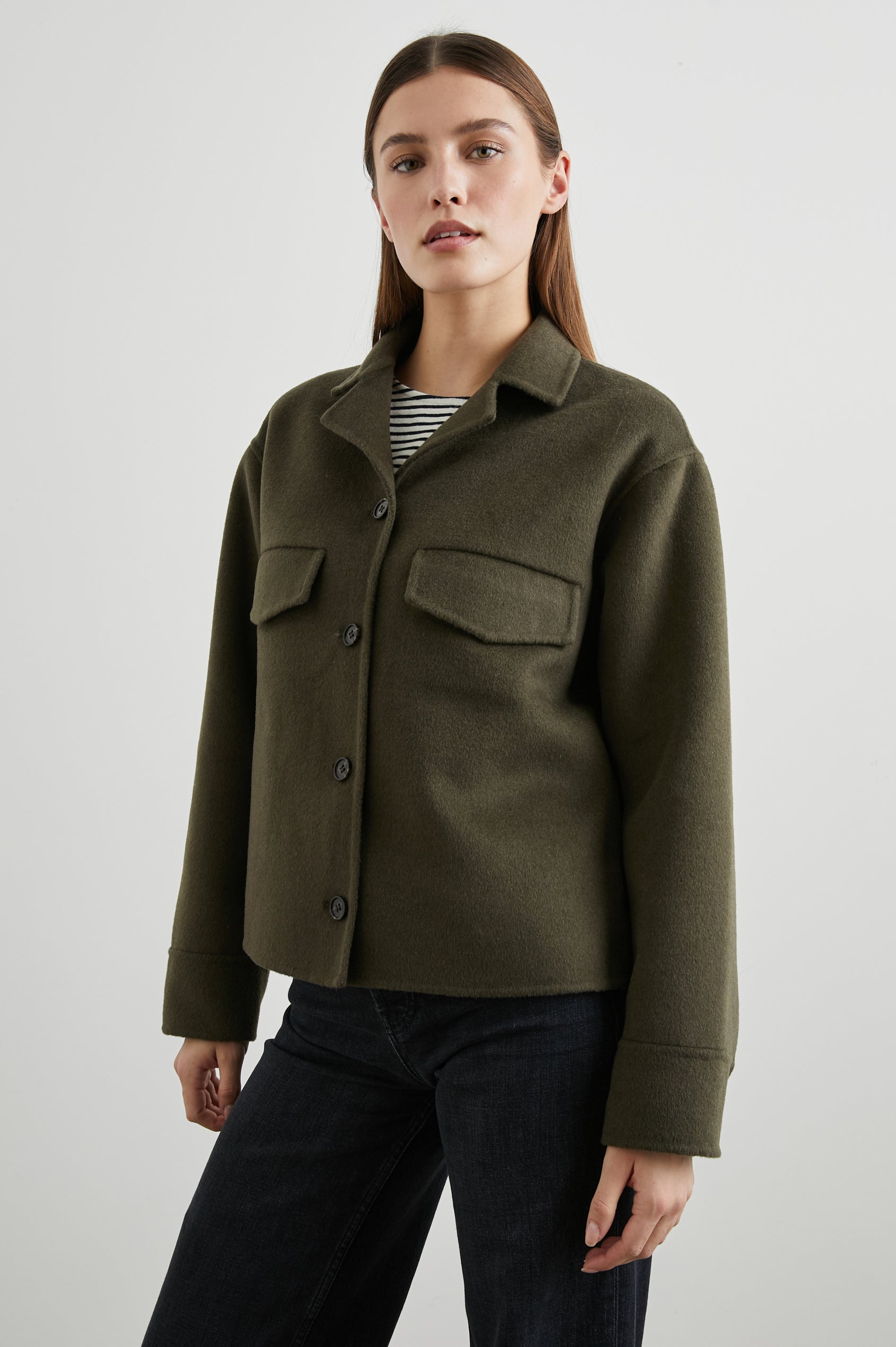 Riley Jacket with Button Closure, a Notched Collar, Two Chest Flap Pockets and Button Cuffs in Olive Colorway - Front View Featured on Model 