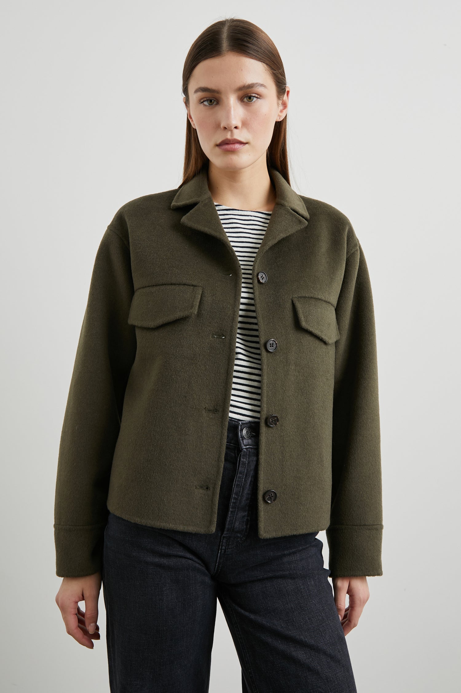 Riley Jacket with Button Closure, a Notched Collar, Two Chest Flap Pockets and Button Cuffs in Olive Colorway - Front View Featured on Model 