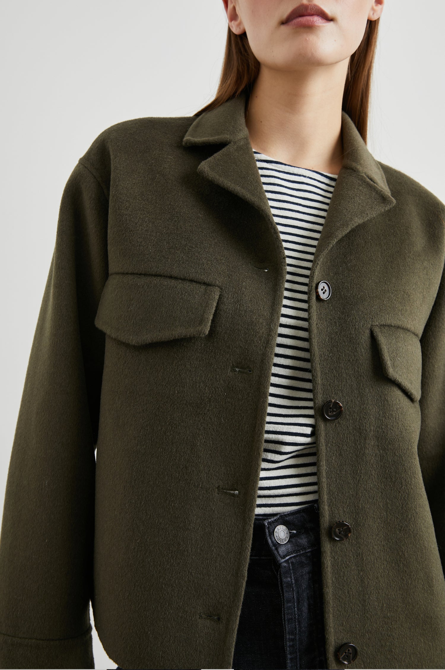 Riley Jacket with Button Closure, a Notched Collar, Two Chest Flap Pockets and Button Cuffs in Olive Colorway - Front View Featured on Model 