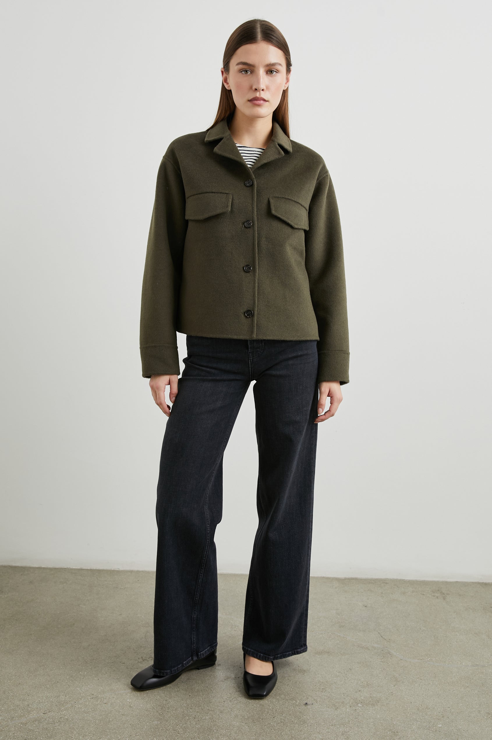Riley Jacket with Button Closure, a Notched Collar, Two Chest Flap Pockets and Button Cuffs in Olive Colorway - Front Full Body View Featured on Model 