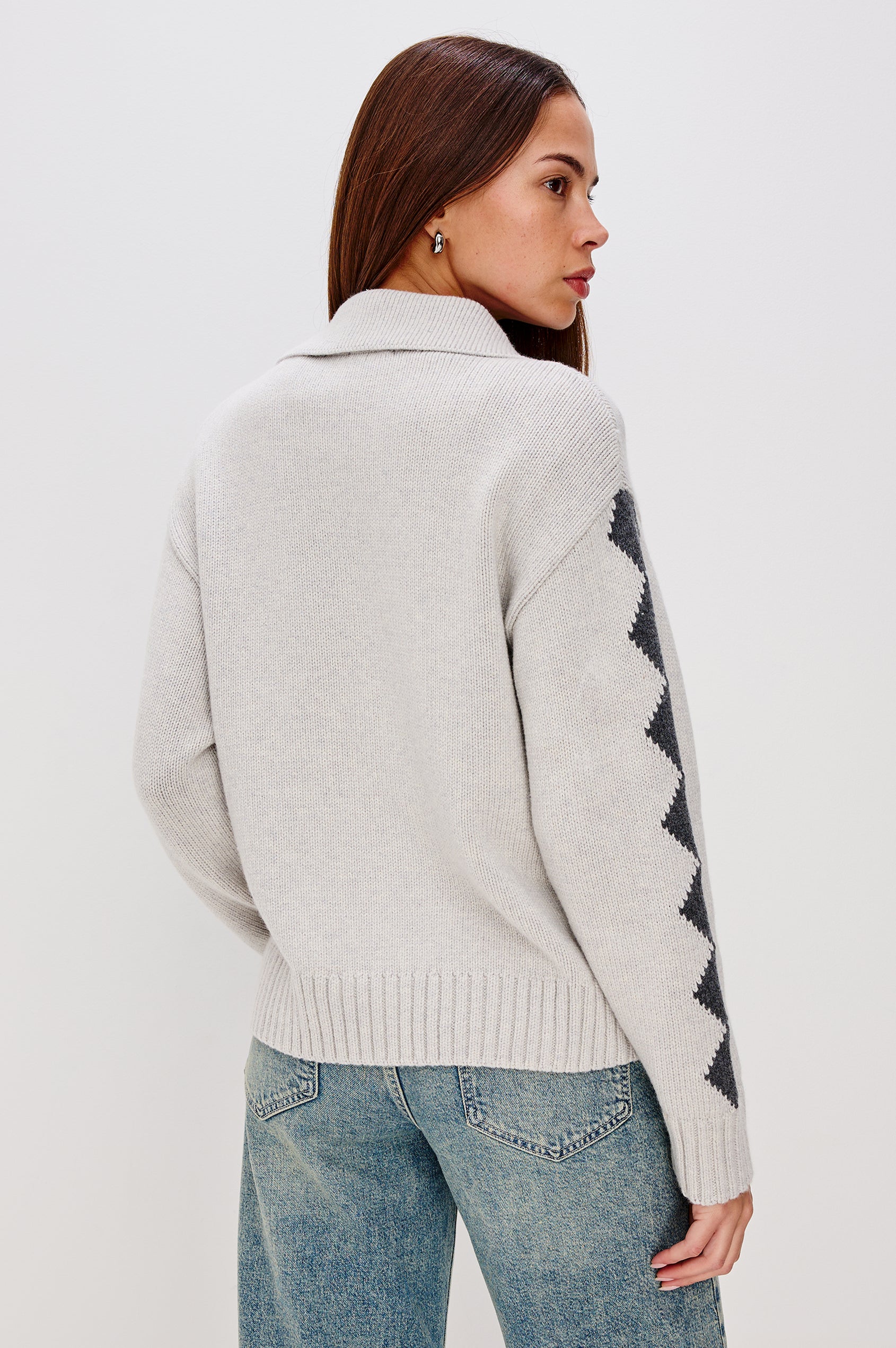 Rhea Longline Cardigan in Wool Blend With Skier Motifs, Stand Collar, Diamond Detailing at Long Sleeves, Relaxed Fit, and Front Zipper in Powder Grey Colorway - Upper Body Back View Featured on Model