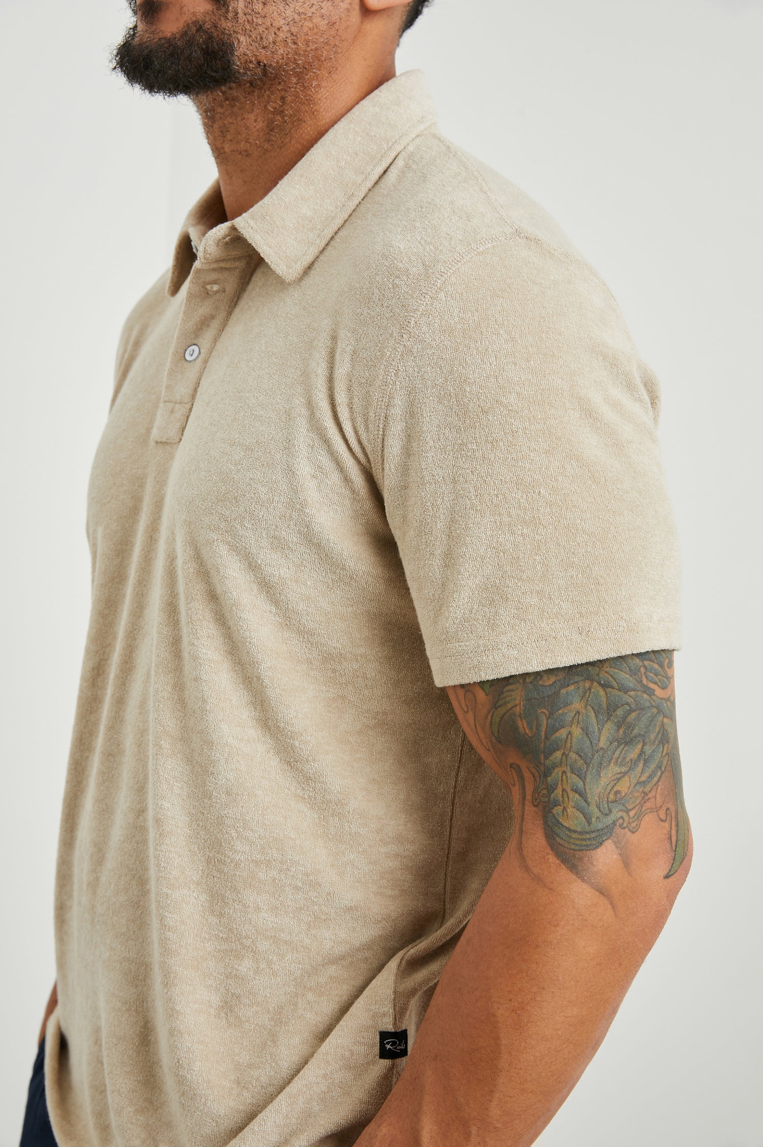 Rhen Short-Sleeve Polo Shirt with a Three-Button Placket in Chickpea Colorway - Side View Featured on Model