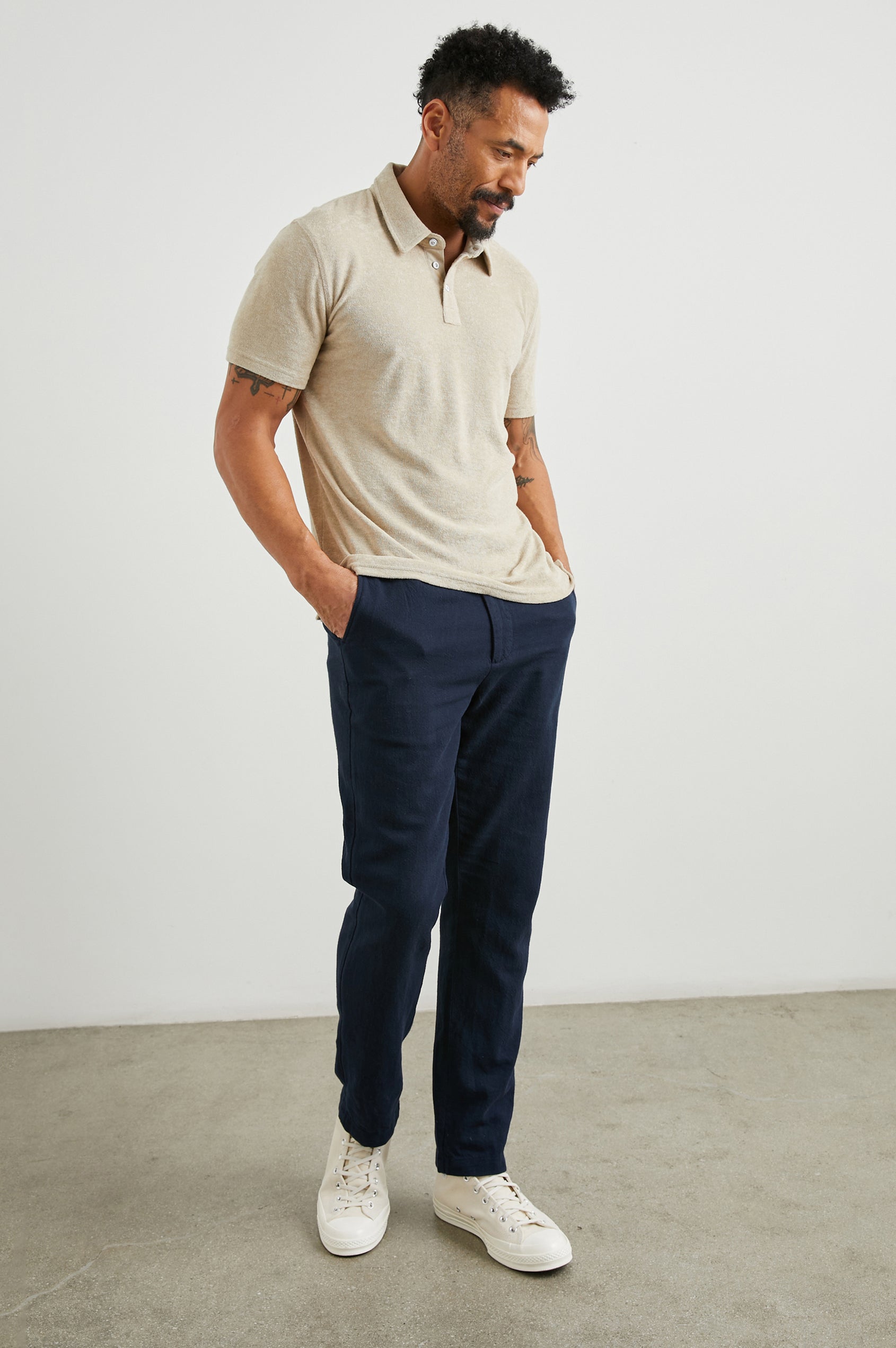 Rhen Short-Sleeve Polo Shirt with a Three-Button Placket in Chickpea Colorway - Front Full Body View Featured on Model