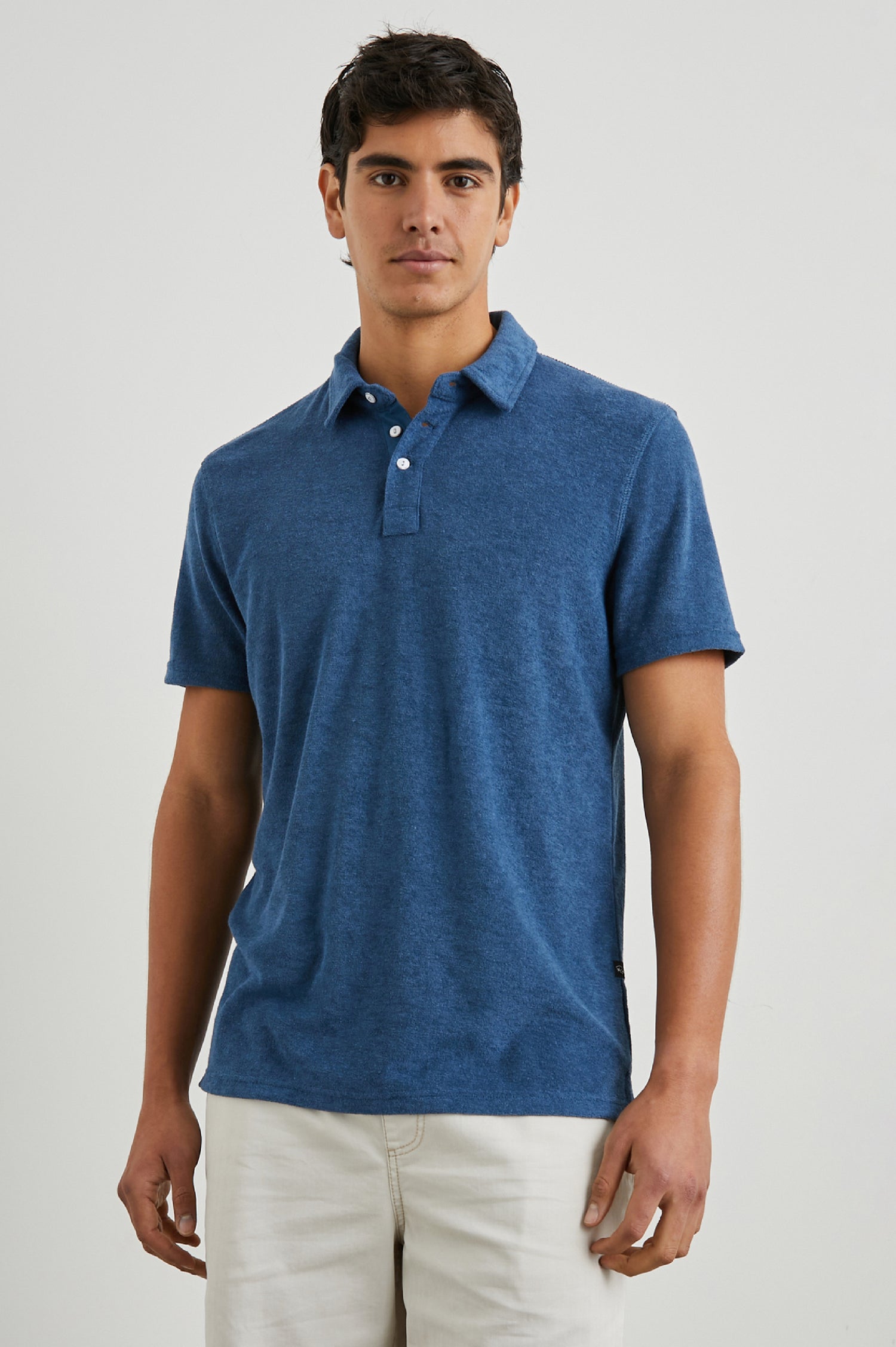 Rhen Short-Sleeve Polo Shirt with a Three-Button Placket in Ensign Blue Colorway - Front View Featured on Model