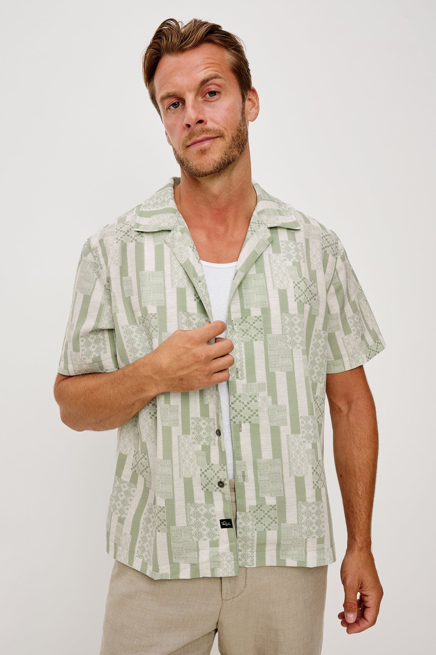 Rhodes Boxy Button-Up Shirt in Crepe With Back Box Pleat, Vintage-Inspired Notched Collar, Front Buttons, and Short Sleeves in Patchwork Stripe Sage Colorway - Upper Body Front View Featured on Model