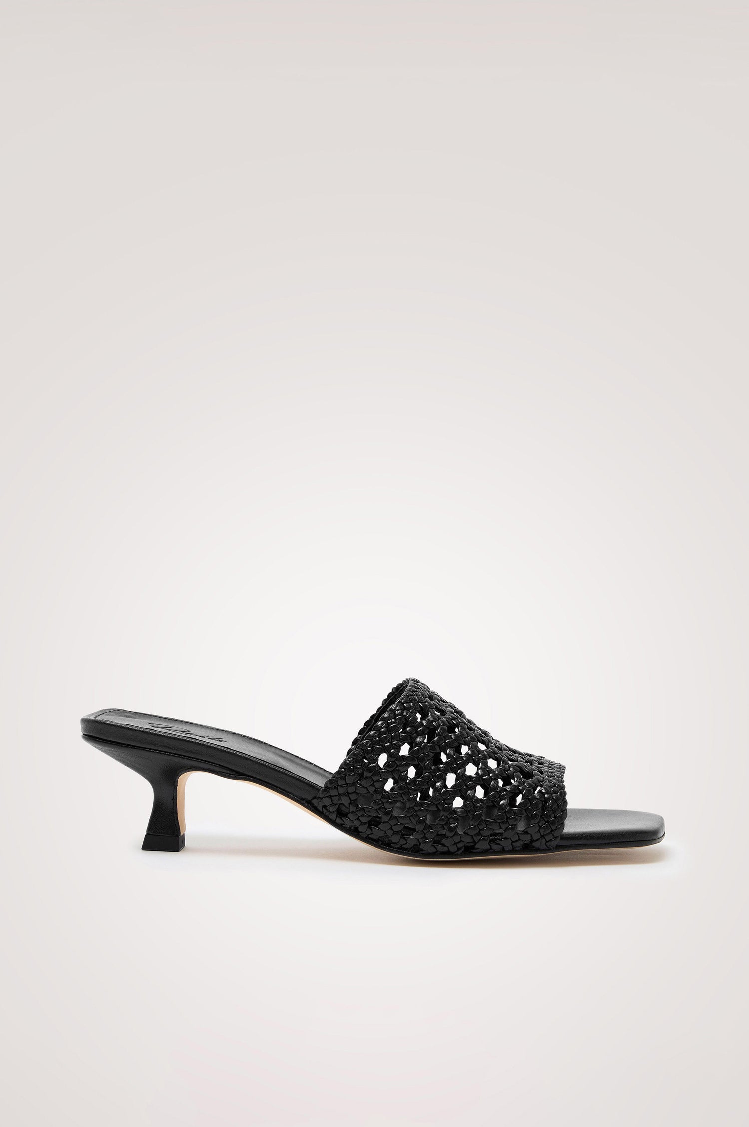 Rimini Mule Heel in Leather With Woven Upper, Square Toe, and Cushioned Footbed With Branded Embossed Detail in Black Colorway - Side View Featured