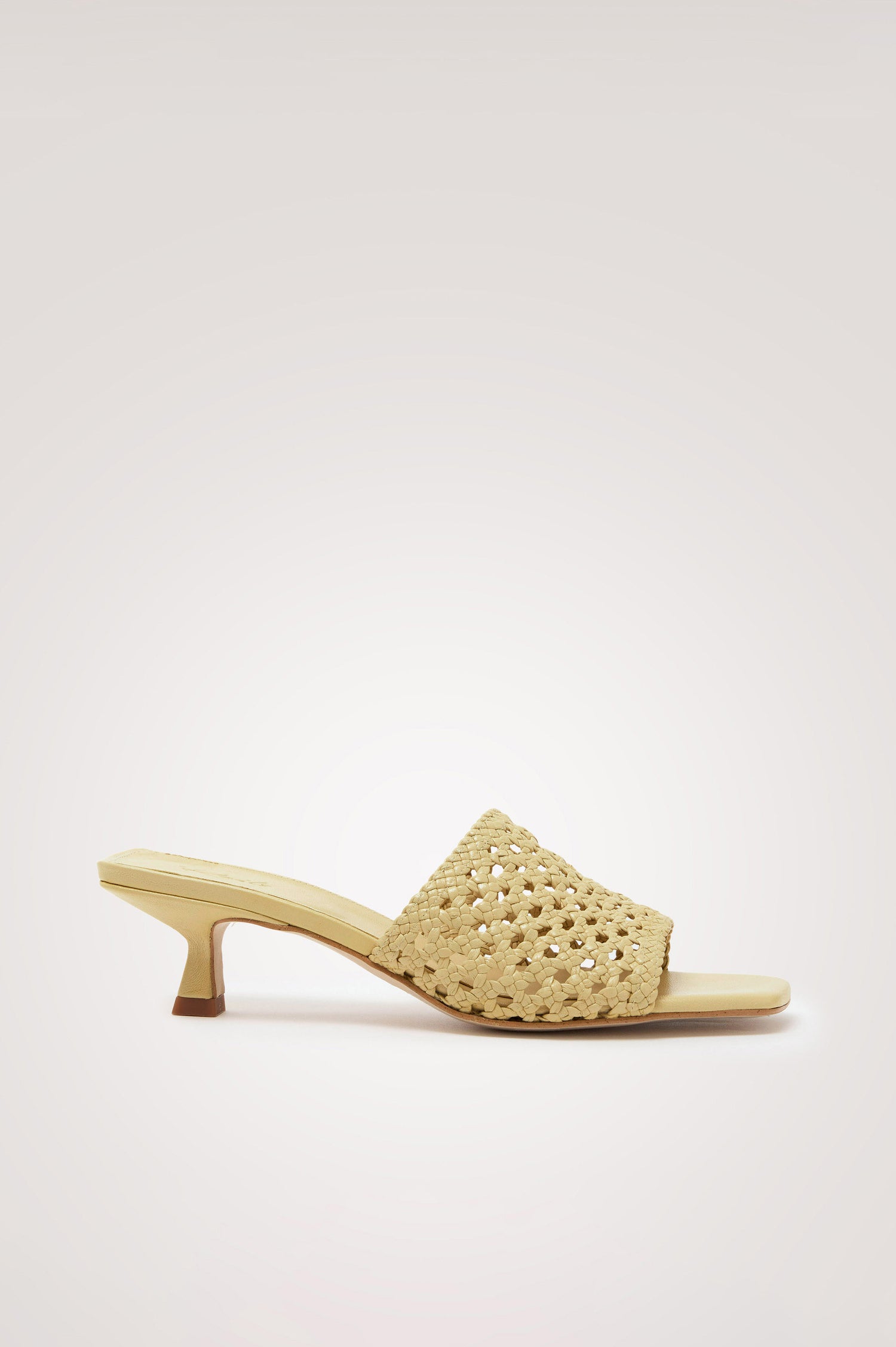 Rimini Mule Heel in Leather With Woven Upper, Square Toe, and Cushioned Footbed With Branded Embossed Detail in Butter Yellow Colorway - Side View Featured