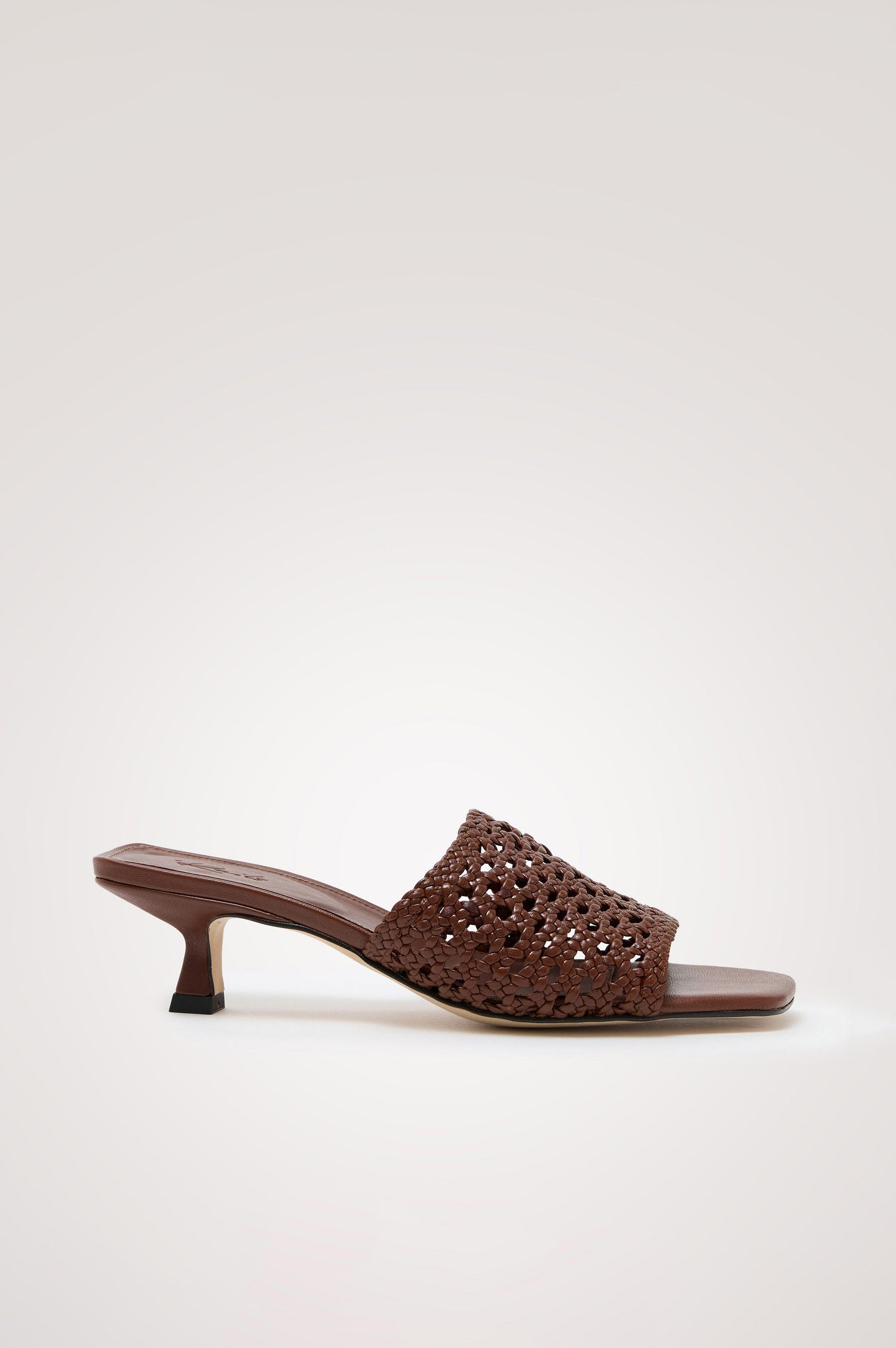 Rimini Mule Heel in Leather With Woven Upper, Square Toe, and Cushioned Footbed With Branded Embossed Detail in Dark Brown Colorway - Side View Featured