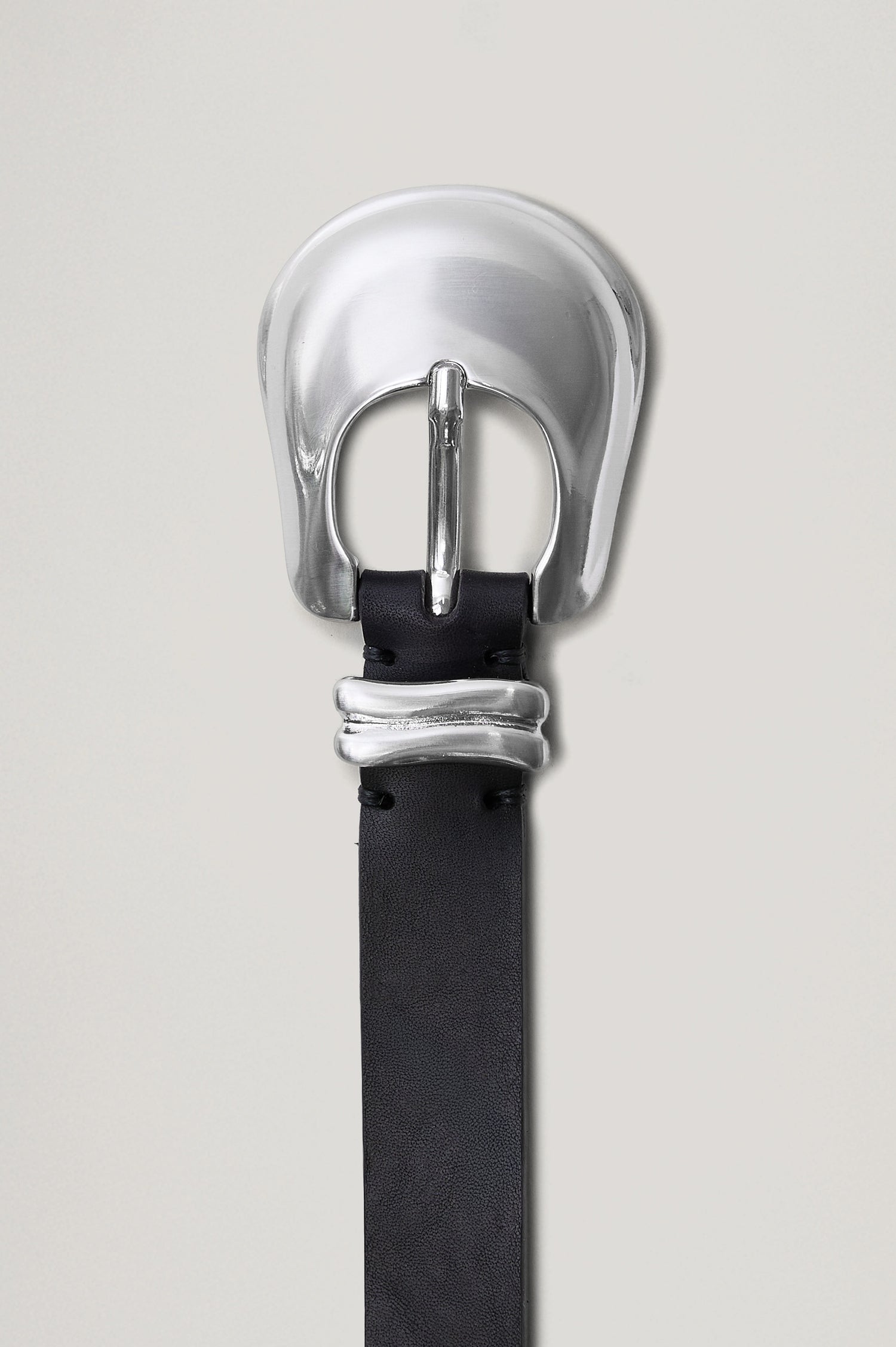 Rodeo black leather belt featuring a western-style engraved silver buckle and hardware. Front view of belt featured not on model.