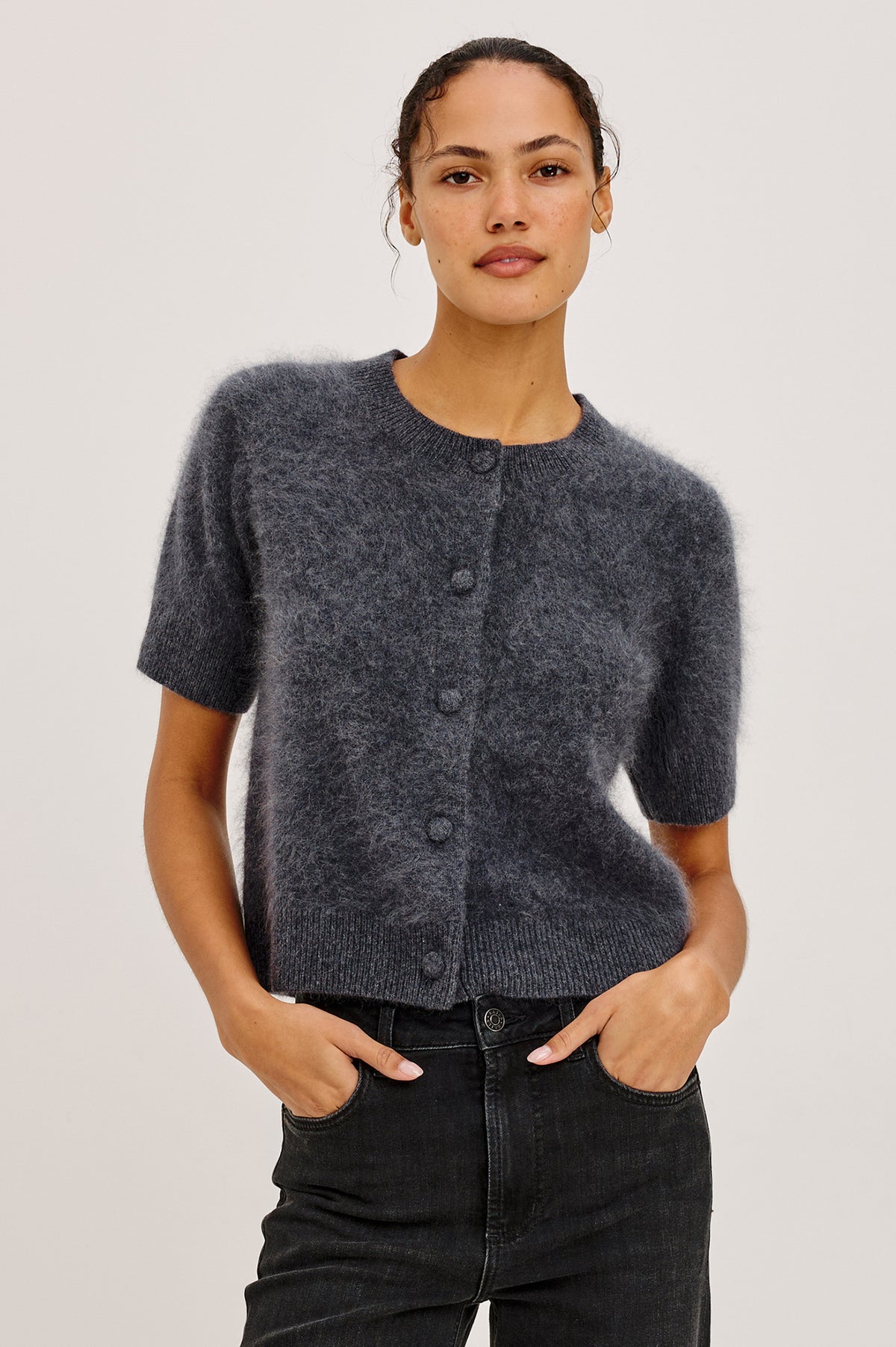 Roman Cardigan Sweater in Brushed Wool With Fluffy Feel With Slightly Cropped Fit, Crew Neck, Self-Covered Front Buttons, Short Sleeves, and Ribbed Trim in Charcoal Colorway - Upper Body Front View Featured on Model