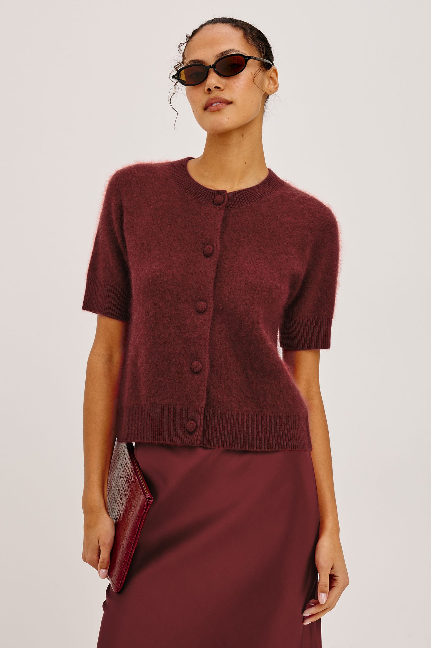 Roman Cardigan Sweater in Brushed Wool With Fluffy Feel With Slightly Cropped Fit, Crew Neck, Self-Covered Front Buttons, Short Sleeves, and Ribbed Trim in Crimson Colorway - Upper Body Front View Featured on Model