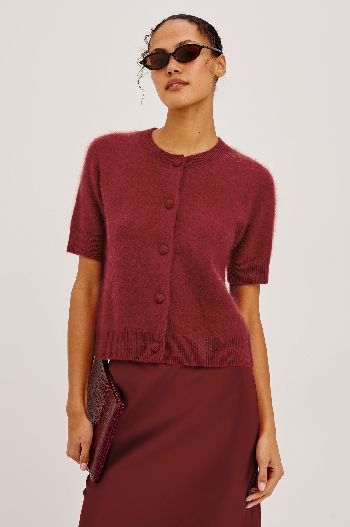 Roman Cardigan Sweater in Brushed Wool With Fluffy Feel With Slightly Cropped Fit, Crew Neck, Self-Covered Front Buttons, Short Sleeves, and Ribbed Trim in Crimson Colorway - Upper Body Front View Featured on Model