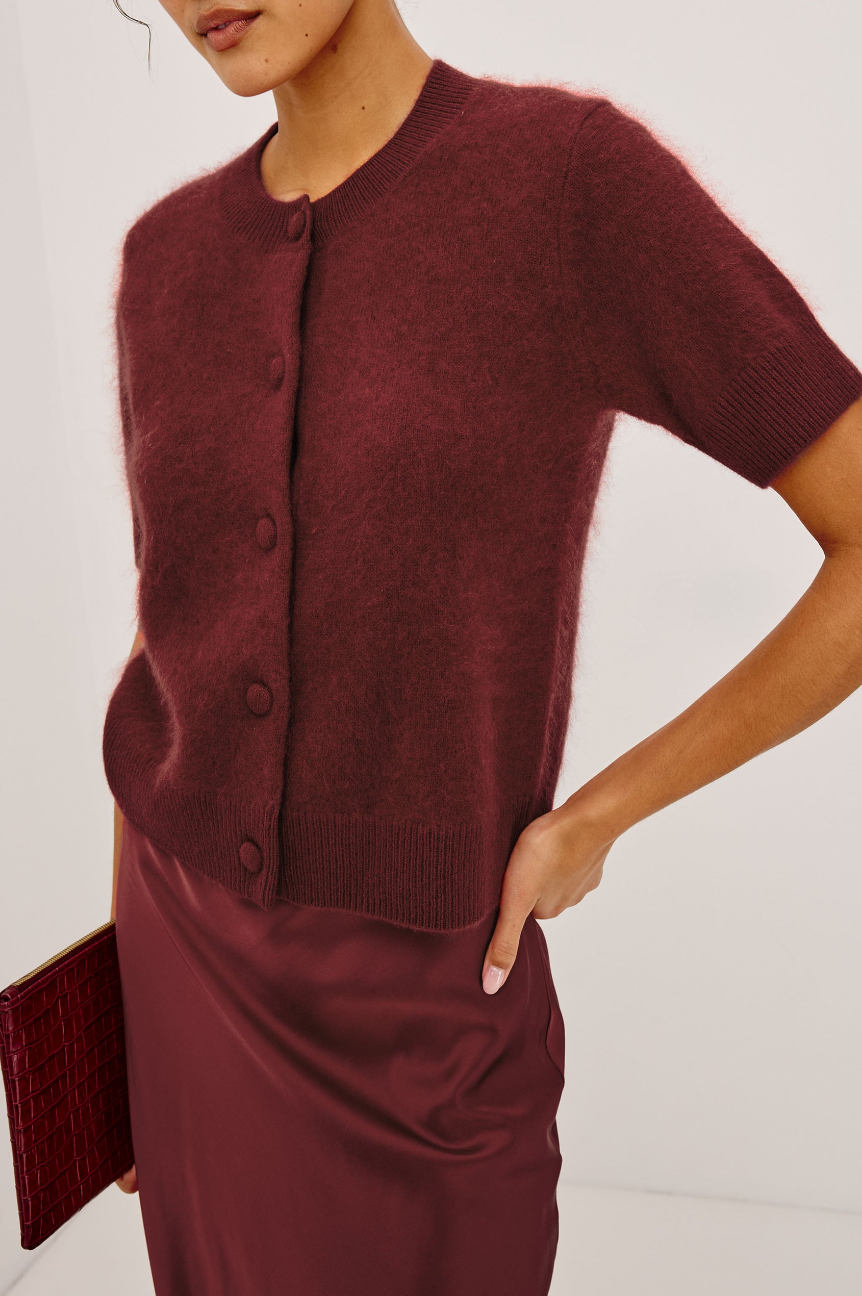 Roman Cardigan Sweater in Brushed Wool With Fluffy Feel With Slightly Cropped Fit, Crew Neck, Self-Covered Front Buttons, Short Sleeves, and Ribbed Trim in Crimson Colorway - Upper Body Front View Featured on Model