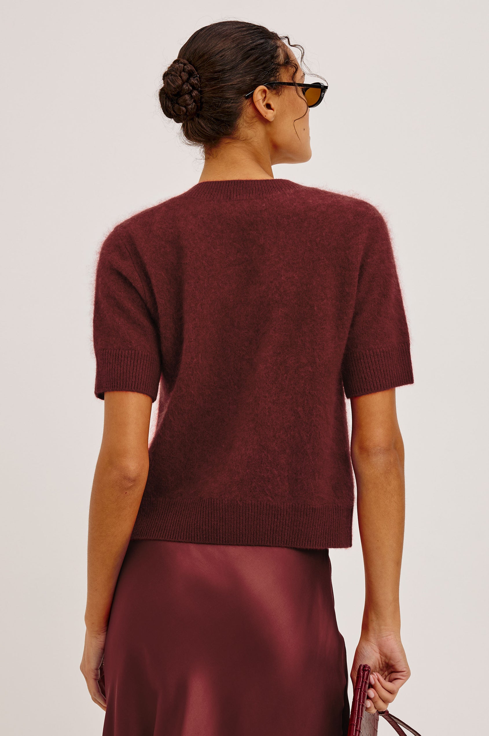 Roman Cardigan Sweater in Brushed Wool With Fluffy Feel With Slightly Cropped Fit, Crew Neck, Self-Covered Front Buttons, Short Sleeves, and Ribbed Trim in Crimson Colorway - Upper Body Back View Featured on Model