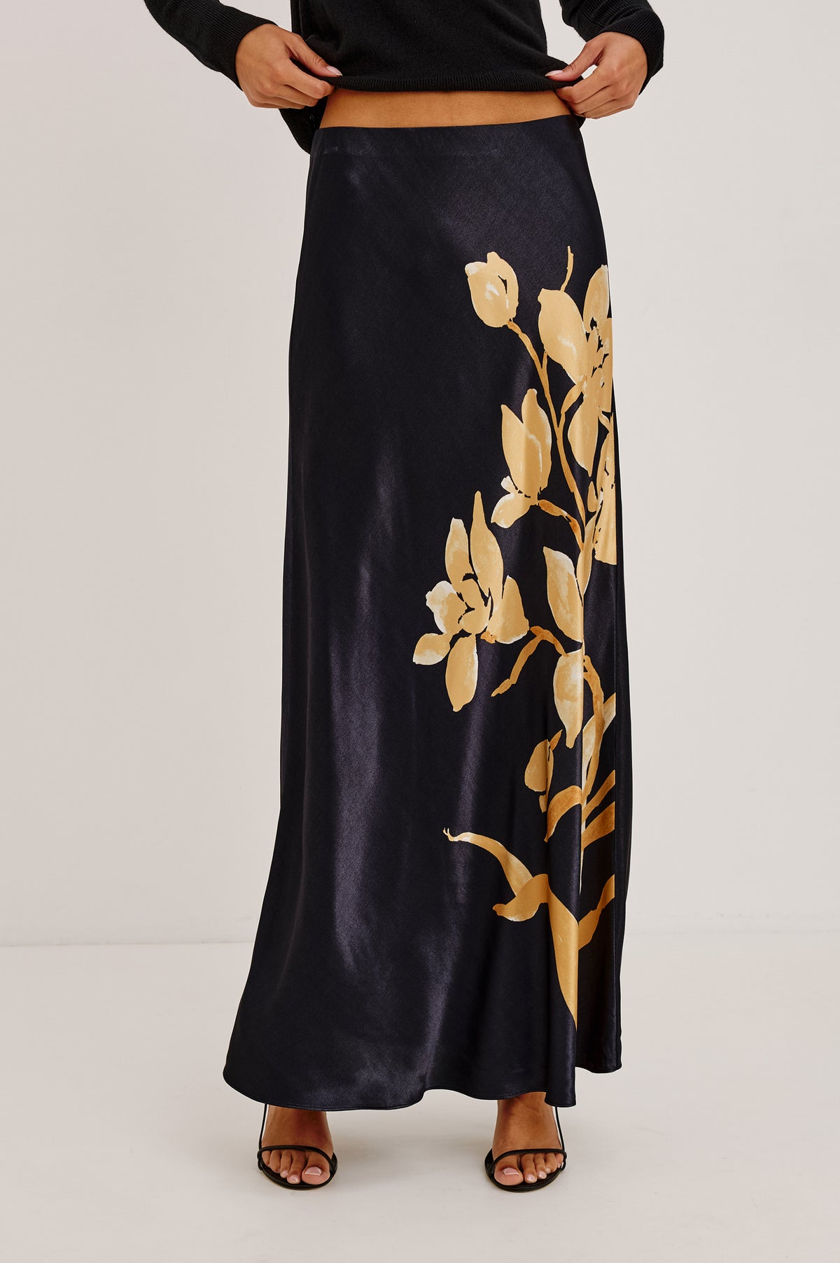 Romina Skirt in Satin With Floral Placement Print, Bias Cut, and Maxi Length in Gold Lily Colorway - Upper Body Front View Featured on Model.