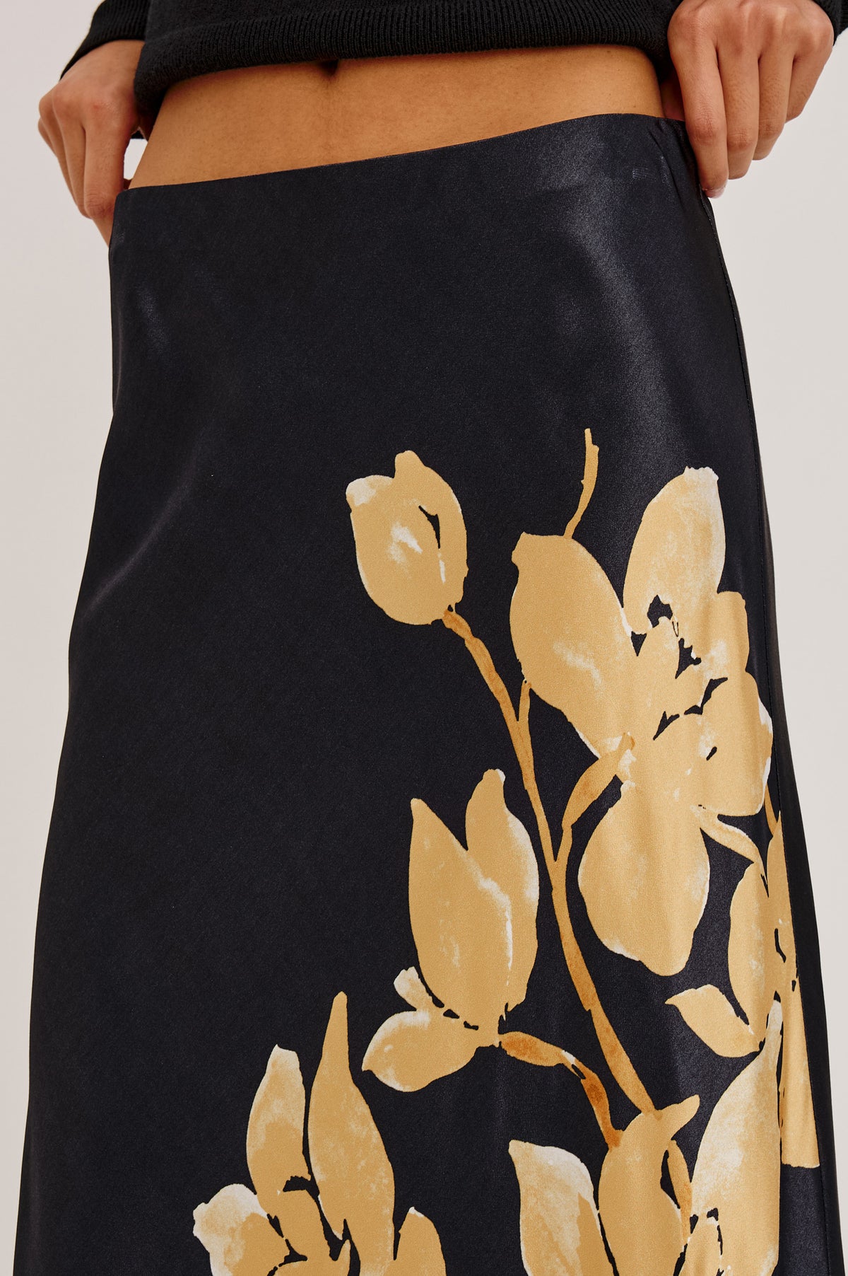 Romina Skirt in Satin With Floral Placement Print, Bias Cut, and Maxi Length in Gold Lily Colorway - Upper Body Front Detail View Featured on Model.