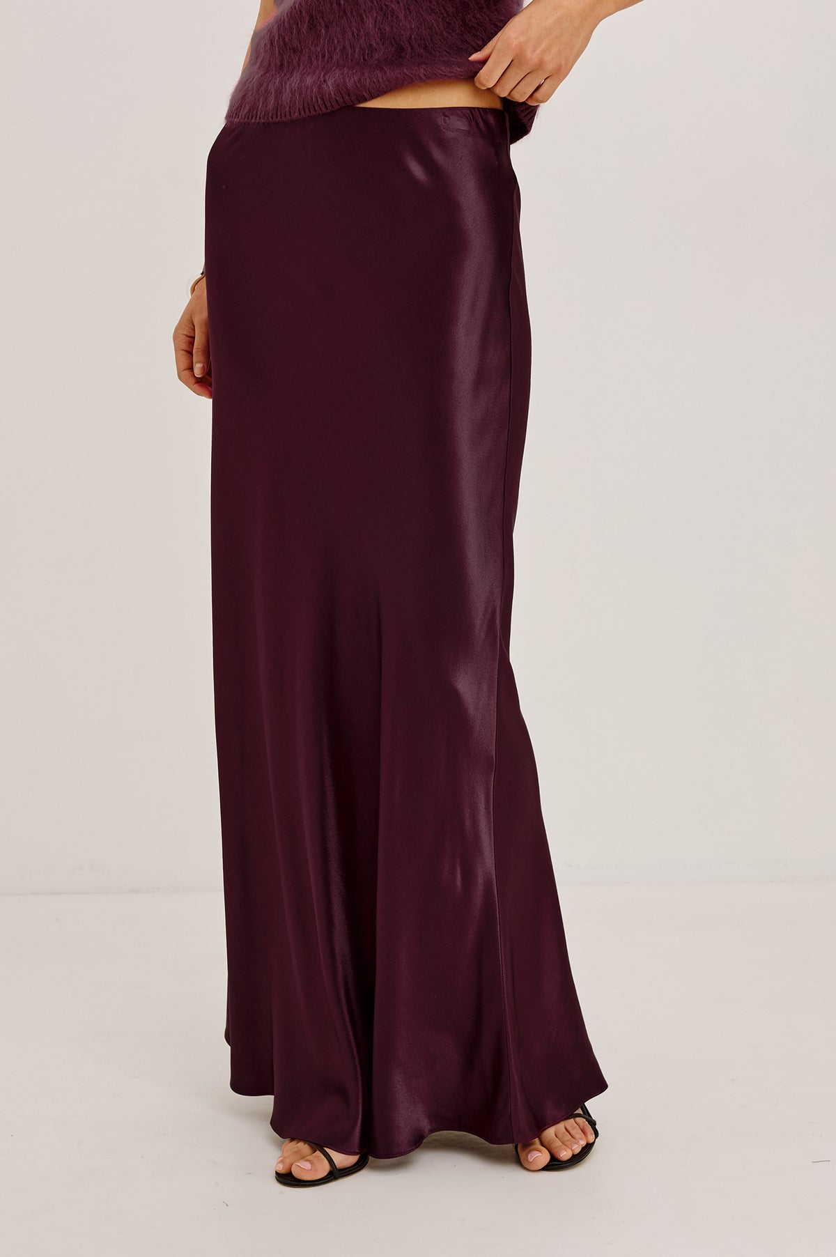 Romina Maxi Skirt Bias Cut in Satin-Back Crepe With Elastic High Waist in Wine Colorway - Upper Body Front Detail View Featured on Model.